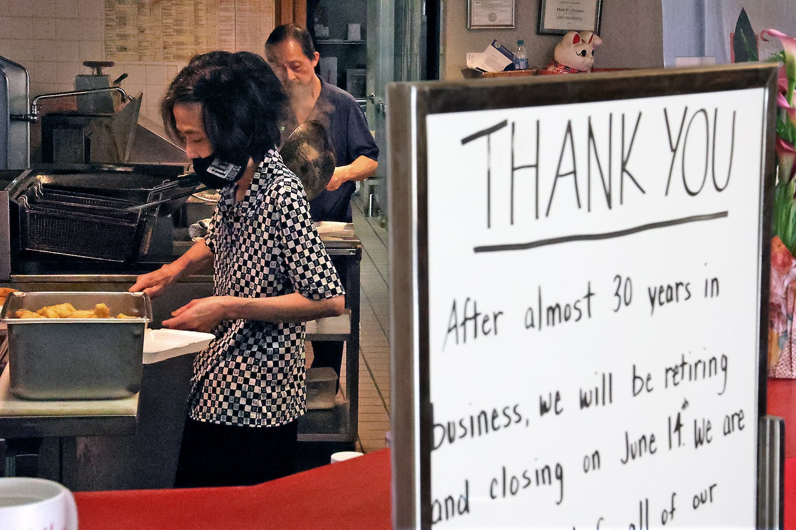 Mark Pi Express owners Kim Hua and his wife Tule cook for the lunch crowd at their restaurant in the Upper Valley Mall. Kim and Tule have owned the restaurant for 28 years and plan to retire when the mall closes on Monday. BILL LACKEY/STAFF