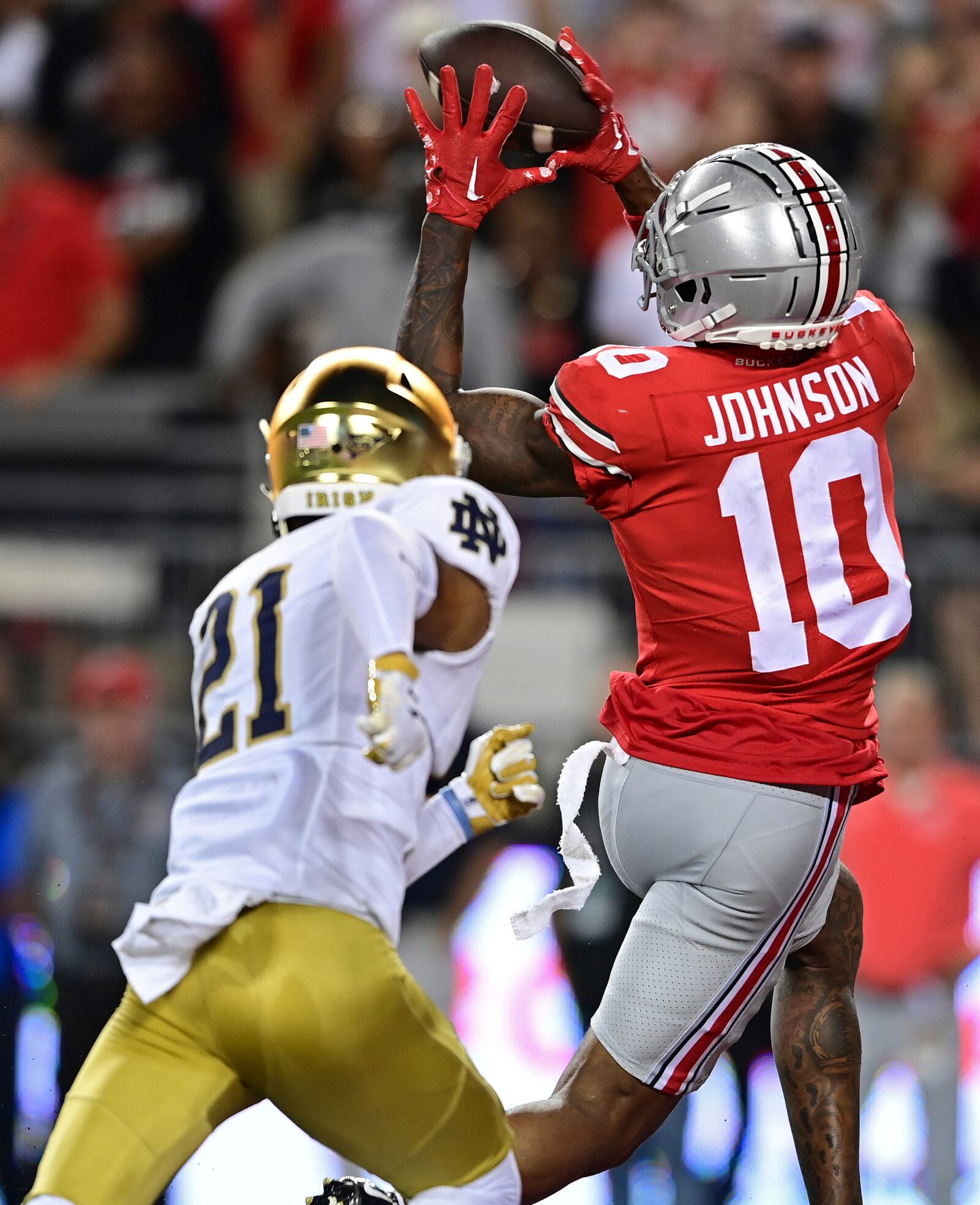 Ohio State wide receiver Xavier Johnson catches a pass for a touchdown against Notre Dame cornerback Jaden Mickey during the third quarter of an NCAA college football game Saturday, Sept. 3, 2022, in Columbus, Ohio. (AP Photo/David Dermer)