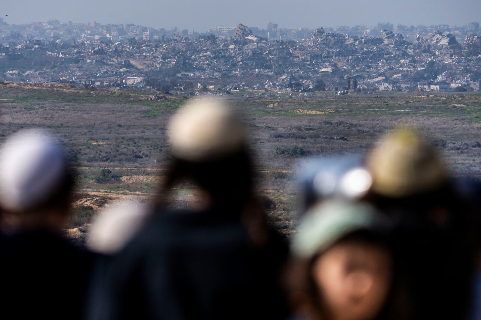 People watch the Gaza Strip from an observation point in Sderot, southern Israel, Monday, Jan. 13, 2025. (AP Photo/Ariel Schalit)