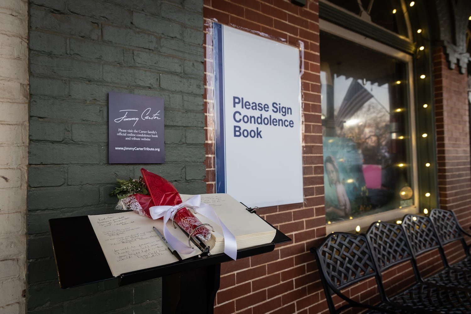 People sign a condolence book near the main street of Plains, Ga., on Jan. 4, 225, before a funeral procession for President Jimmy Carter. (Dustin Chambers/The New York Times)