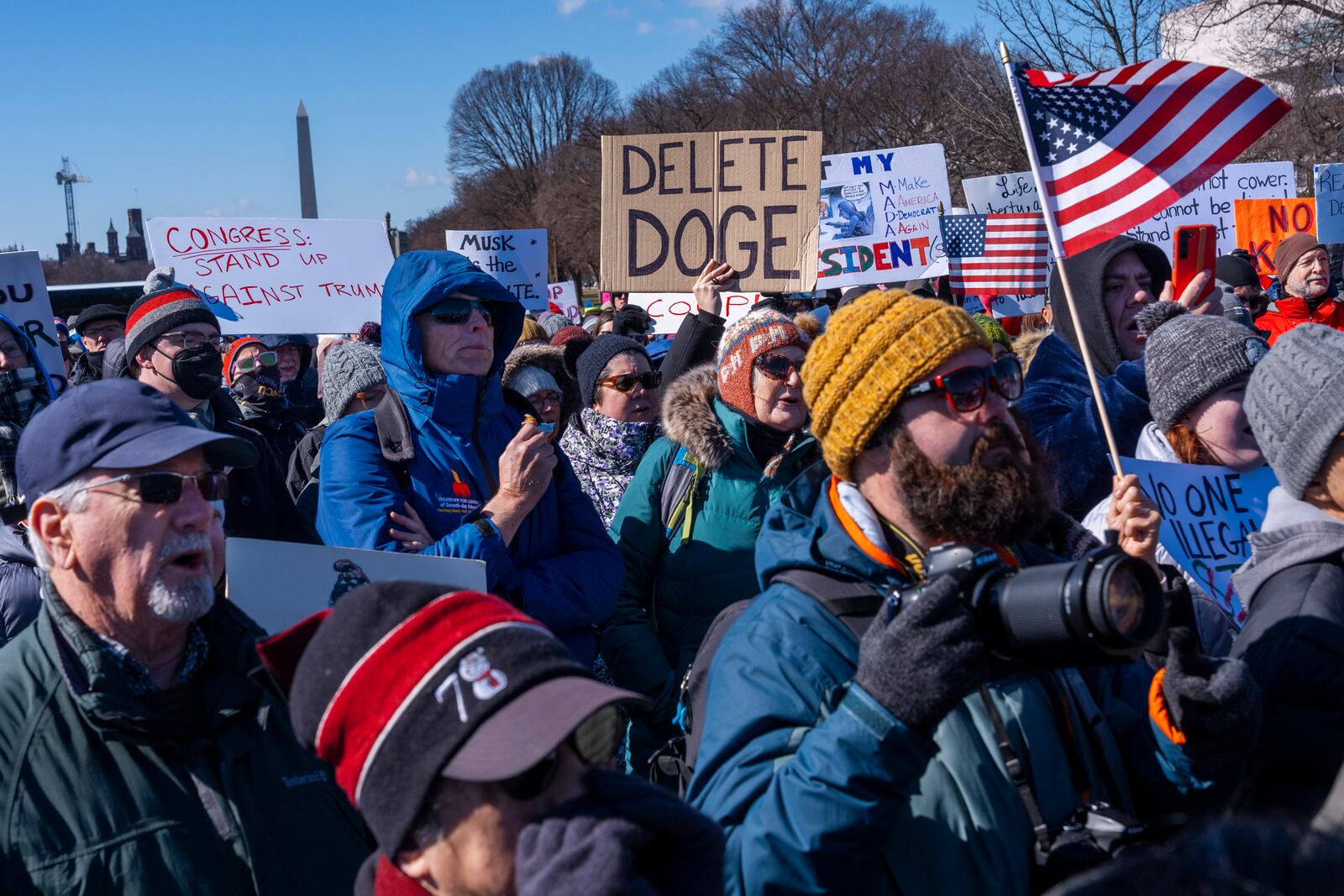 People protest as part of the “No Kings Day” protest on Presidents Day in Washington, in support of federal workers and against recent actions by President Donald Trump and Elon Musk, Monday, Feb. 17, 2025, by the Capitol in Washington. (AP Photo/Jacquelyn Martin)