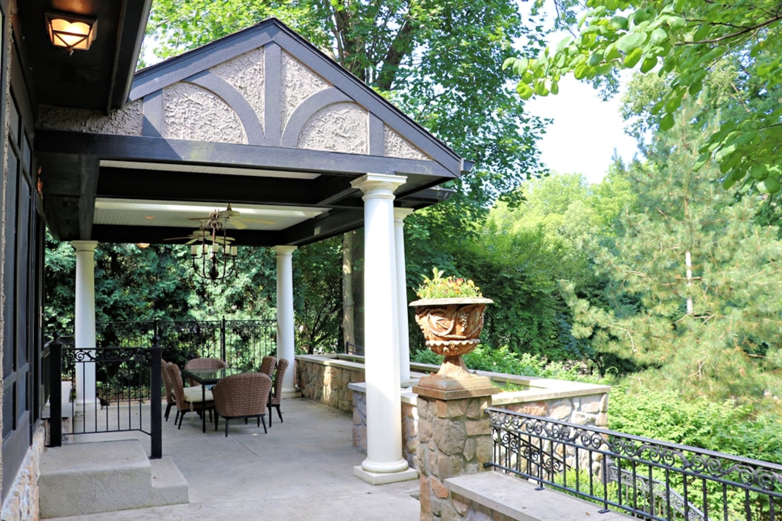 Patio doors open out to the screen-enclosed back porch and terraced garden patio. 