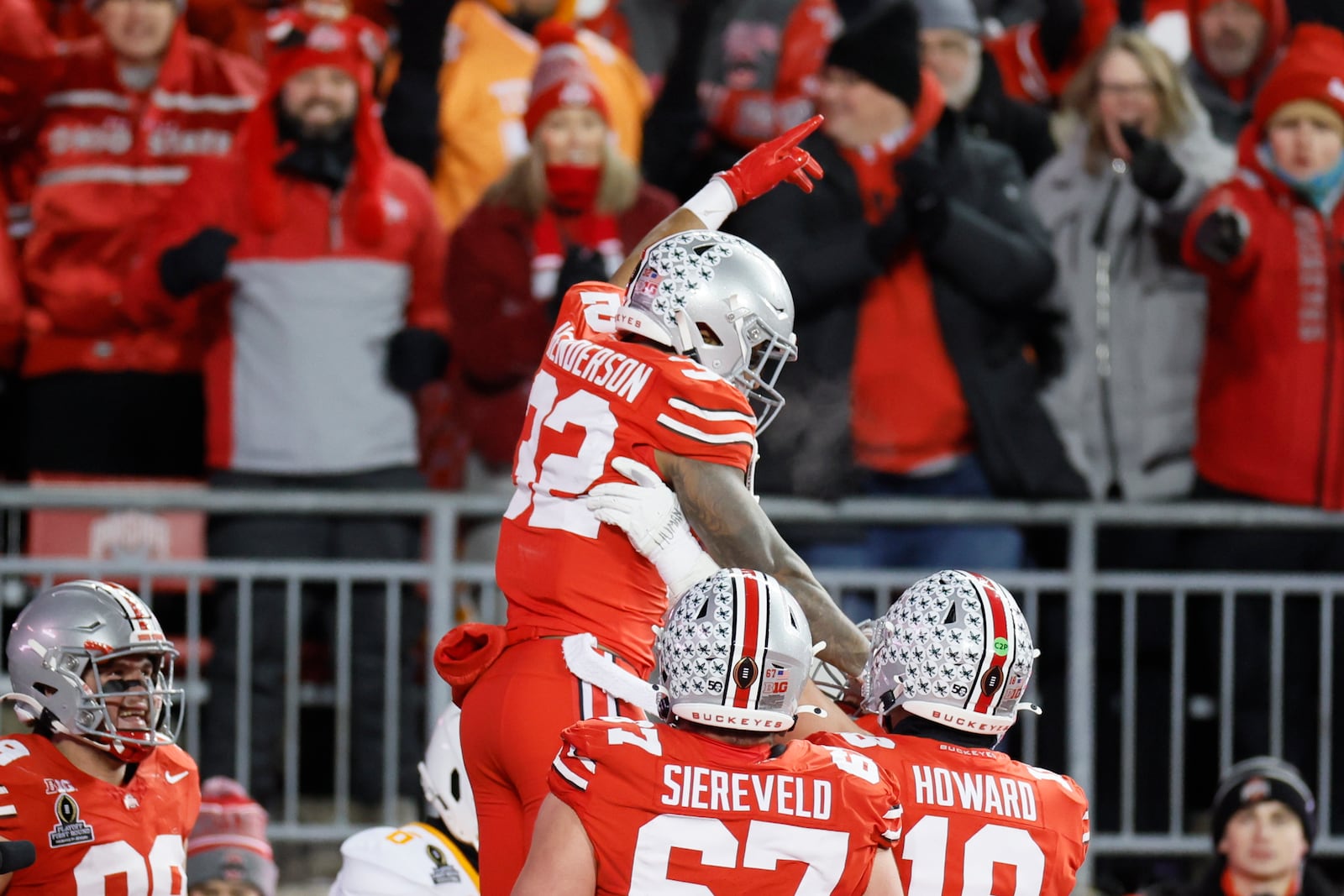 Ohio State running back TreVeyon Henderson, top, celebrates after his touchdown against Tennessee during the first half in the first round of the College Football Playoff, Saturday, Dec. 21, 2024, in Columbus, Ohio. (AP Photo/Jay LaPrete)