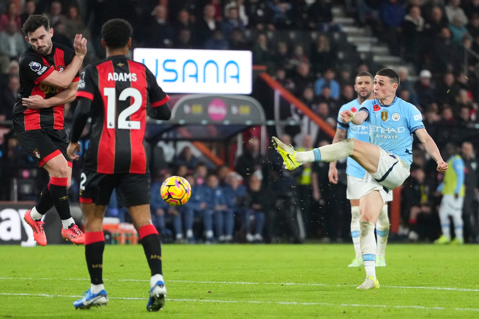 Manchester City's Phil Foden, right, attempts a shot on goal during the English Premier League soccer match between Bournemouth and Manchester City at the Vitality stadium in Bournemouth, England, Saturday, Nov. 2, 2024. (AP Photo/Kirsty Wigglesworth)