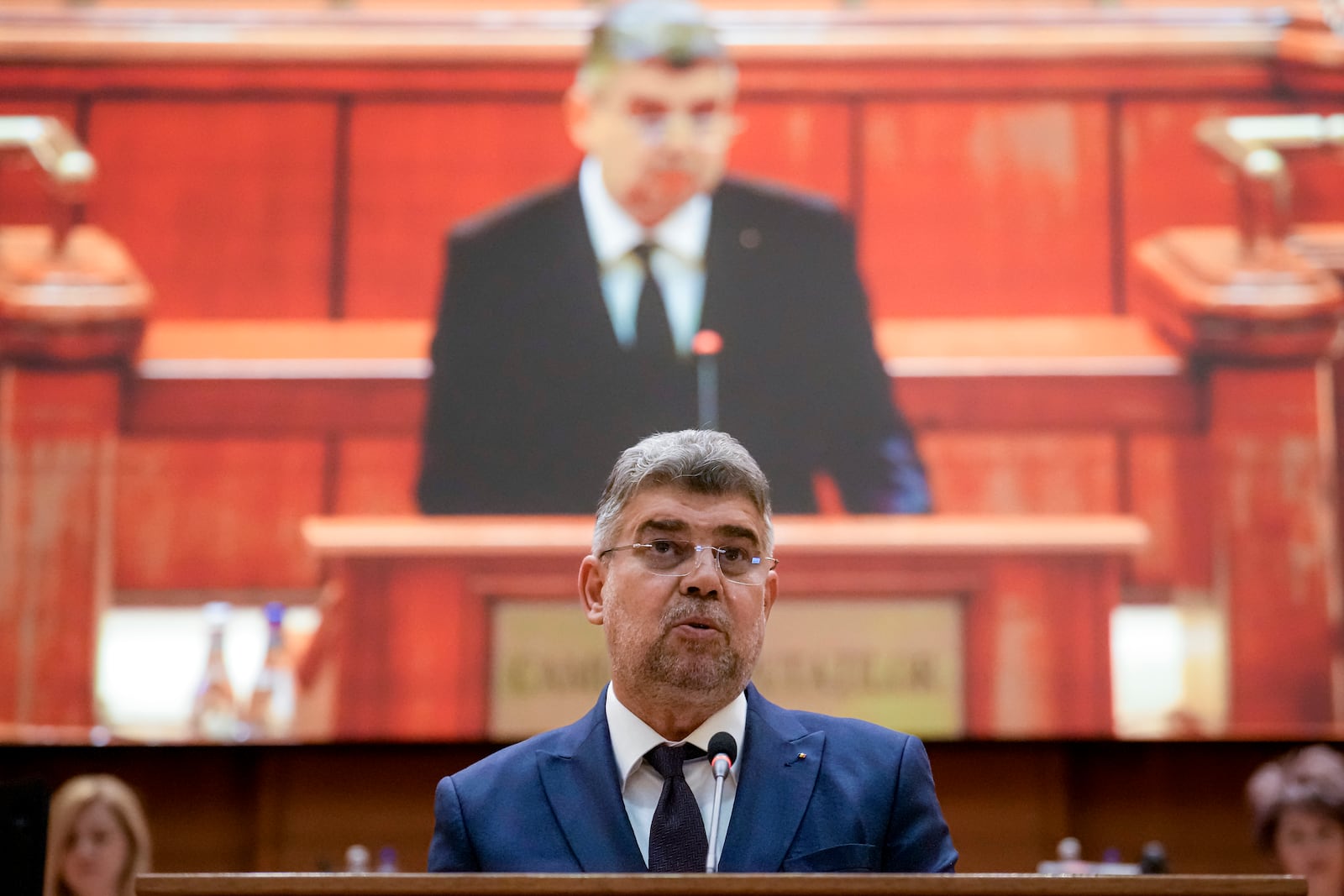 Romanian Prime Minister designate Marcel Ciolacu, the leader of the Social Democratic party, delivers a speech before a confidence vote for him and his team at the parliament in Bucharest, Romania, Monday, Dec. 23, 2024. (AP Photo/Vadim Ghirda)