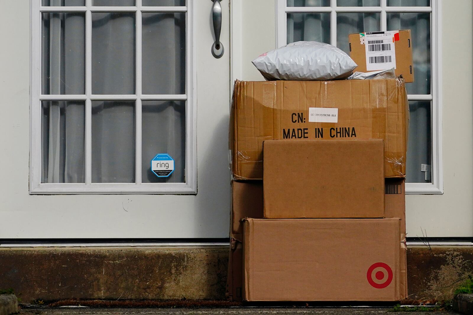 FILE - Packages are seen stacked on the doorstep of a residence, Wednesday, Oct. 27, 2021, in Upper Darby, Pa. (AP Photo/Matt Slocum, File)