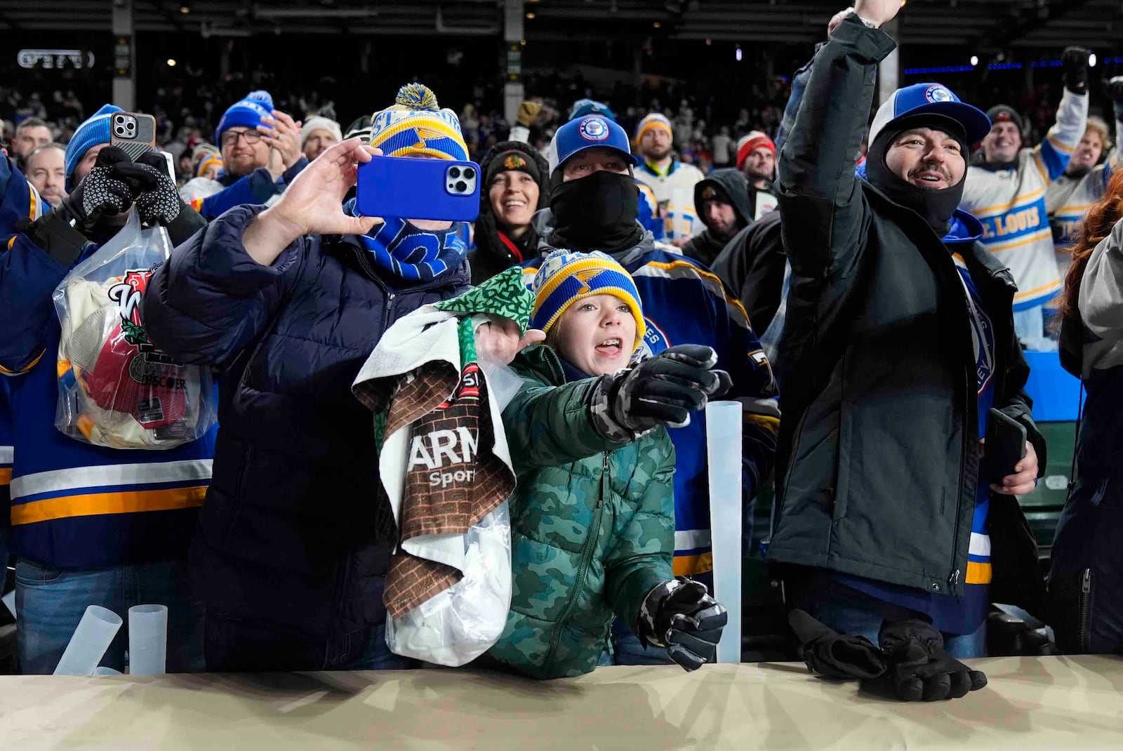 St. Louis Blues fans celebrate after the team's win over the Chicago Blackhawks in the NHL Winter Classic outdoor hockey game at Wrigley Field, Tuesday, Dec. 31, 2024, in Chicago. (AP Photo/Erin Hooley)