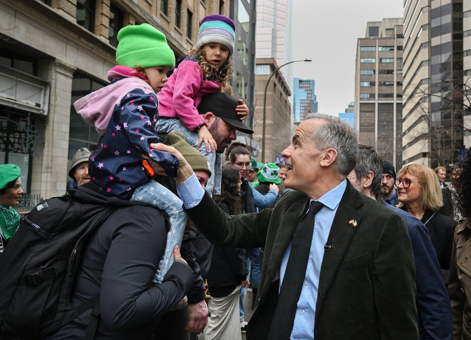 Prime Minister Mark Carney greets members of the crowd during the annual St. Patrick's Day Parade in Montreal, Sunday, March 16, 2025.(Graham Hughes /The Canadian Press via AP)