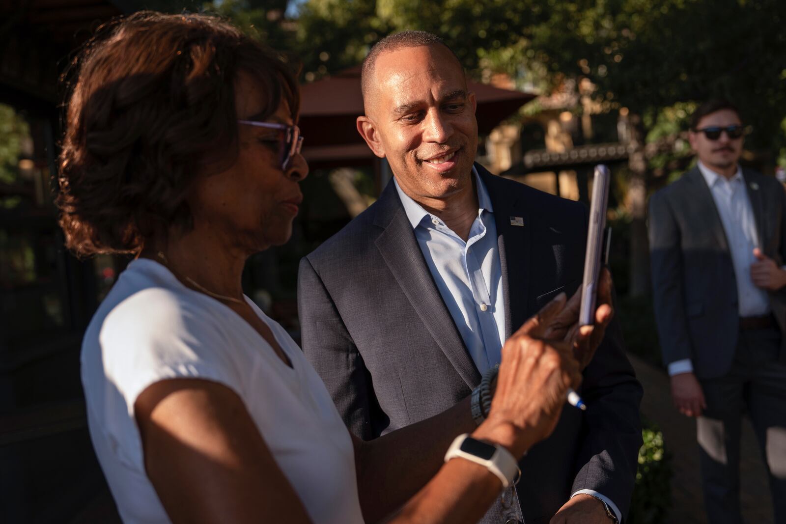 House Minority Leader Hakeem Jeffries, D-N.Y., center, takes a selfie with a supporter, Saturday, Oct. 12, 2024, in Irvine, Calif. (AP Photo/Julia Demaree Nikhinson)