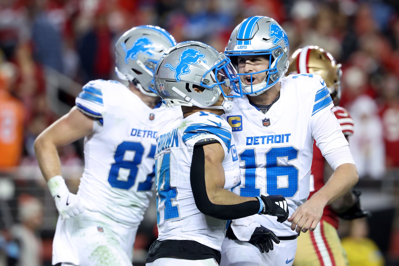 Detroit Lions quarterback Jared Goff (16) celebrates after throwing a touchdown pass to wide receiver Amon-Ra St. Brown (14) during the second half of an NFL football game against the San Francisco 49ers, Monday, Dec. 30, 2024, in Santa Clara, Calif. (AP Photo/Jed Jacobsohn)