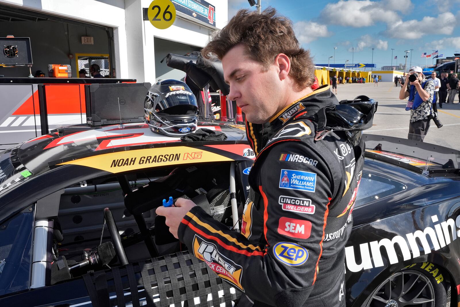 Noah Gragson puts in his ear plugs as he gets ready for practice at the NASACAR Daytona 500 auto race Wednesday, Feb. 12, 2025, at Daytona International Speedway in Daytona Beach, Fla. (AP Photo/Chris O'Meara)