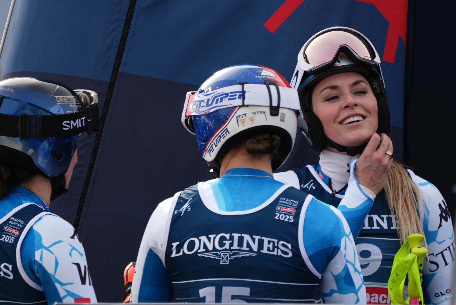 United States' Lindsey Vonn, right, talks to United States' Lauren Macuga, center, and United States' Jacqueline Wiles, right, at the finish area of a downhill run of a women's team combined event, at the Alpine Ski World Championships, in Saalbach-Hinterglemm, Austria, Tuesday, Feb. 11, 2025. (AP Photo/Giovanni Auletta)