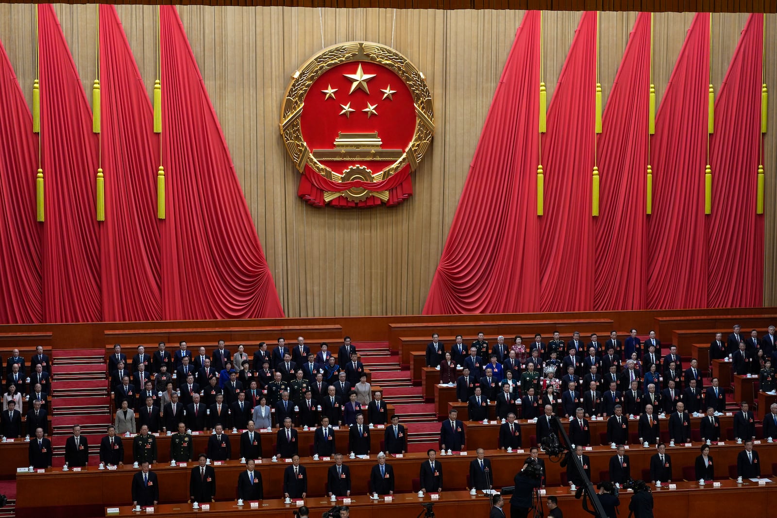 China's top leaders stand for the national anthem during the closing ceremony of the National People's Congress held at the Great Hall of the People in Beijing, Tuesday, March 11, 2025. (AP Photo/Ng Han Guan)