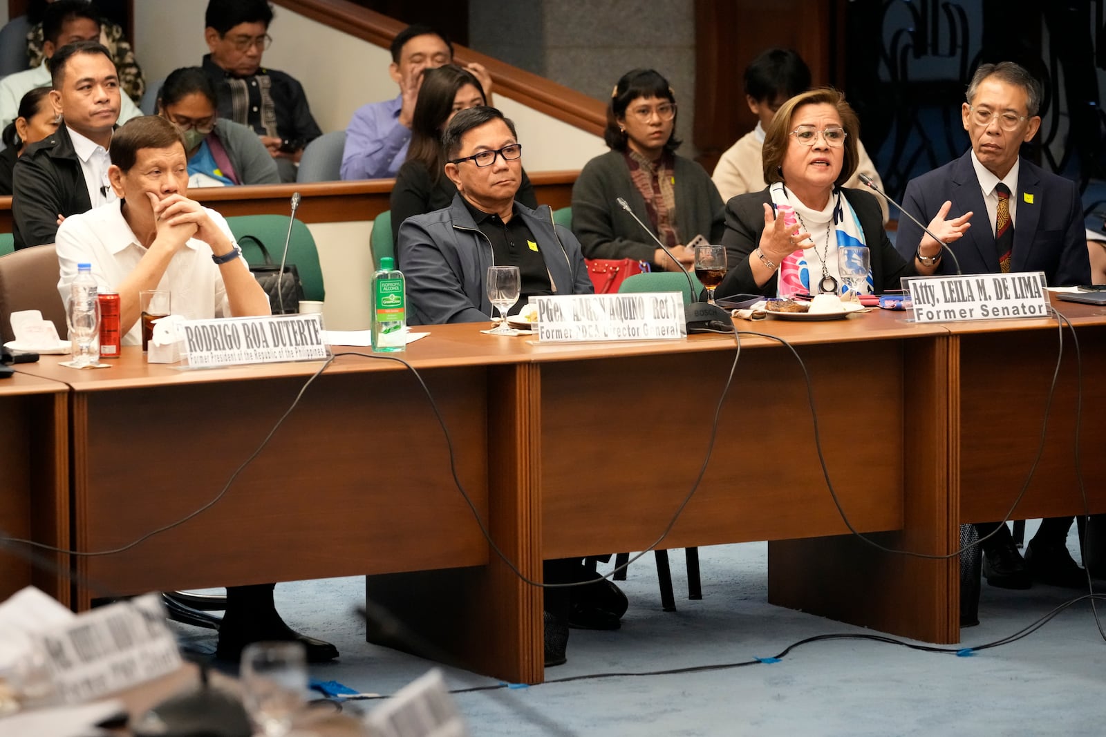 Former senator Leila de Lima, right, speaks beside former Philippine President Rodrigo Duterte, left, during a senate inquiry on the so-called war on drugs during his administration at the Philippine Senate Monday, Oct. 28, 2024, in Manila, Philippines. (AP Photo/Aaron Favila)