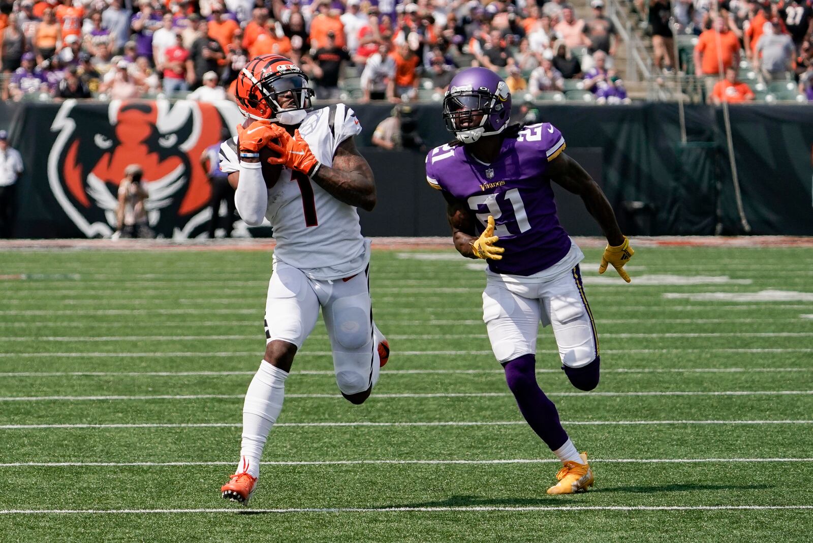 Cincinnati Bengals wide receiver Ja'Marr Chase (1) makes a catch and takes it in for a touchdown past Minnesota Vikings defensive back Bashaud Breeland (21) in the first half of an NFL football game, Sunday, Sept. 12, 2021, in Cincinnati. (AP Photo/Jeff Dean)