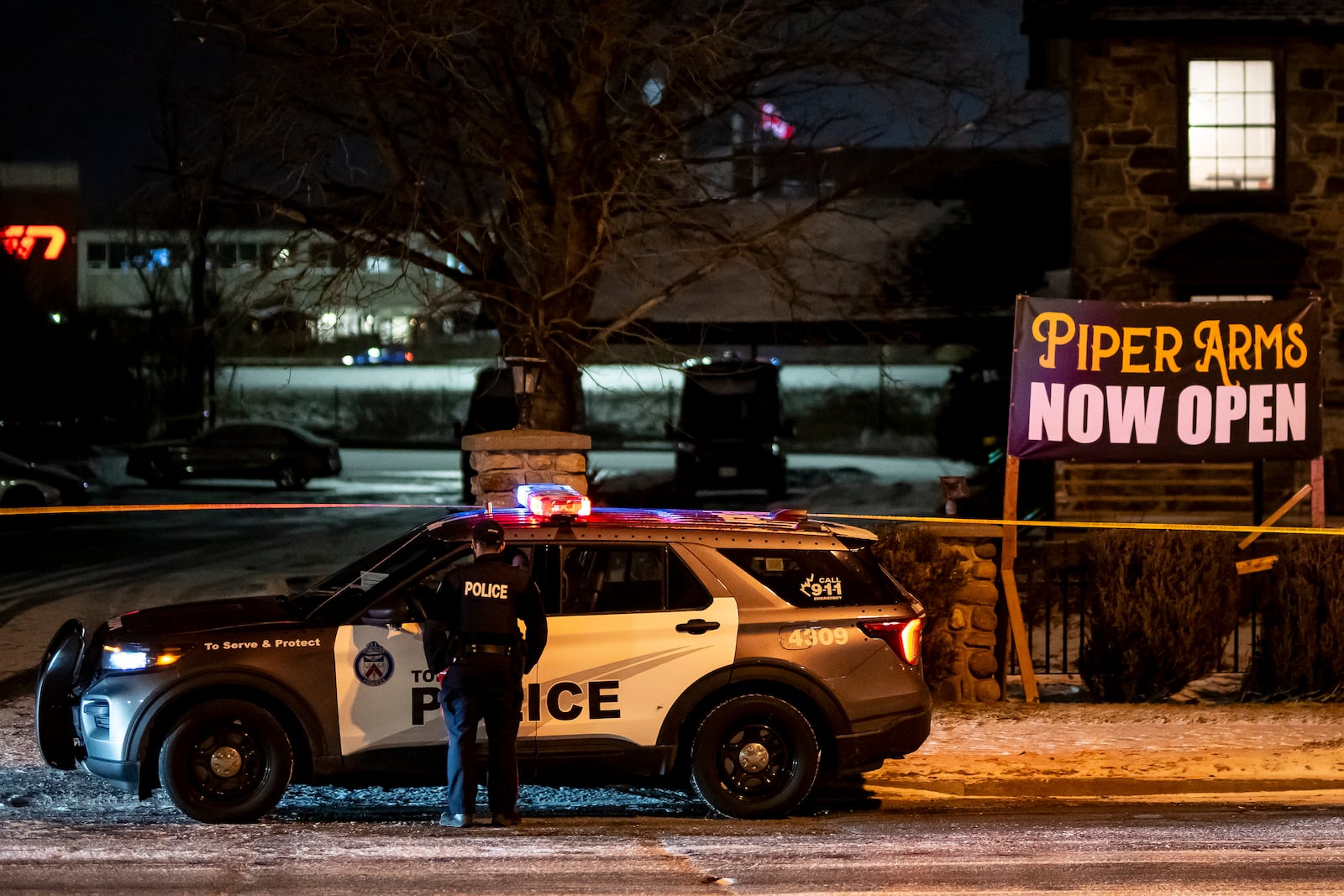 Toronto Police investigate a shooting at the Piper Arms Pub near the Scarborough Town Centre in Toronto on Saturday, March 8, 2025. (Christopher Katsarov/The Canadian Press via AP)