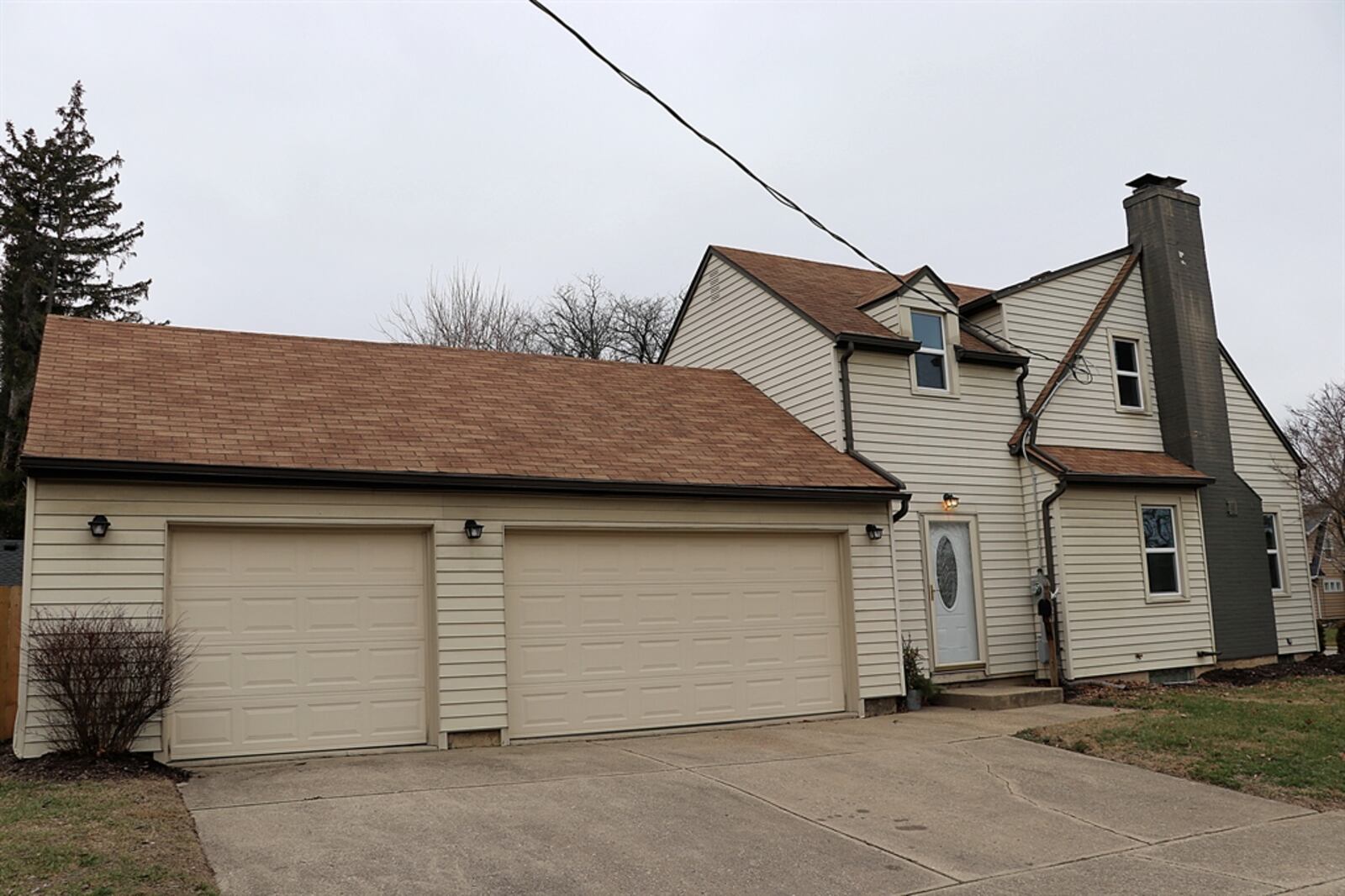 Off the breezeway is the interior access to the three-car garage and entrance to an added half bathroom.