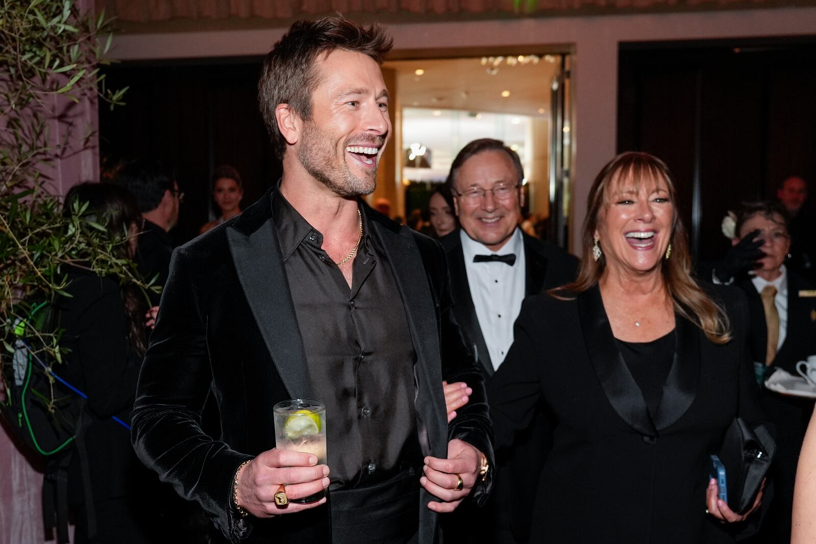 Glen Powell, left, and Cyndy Powell arrive at the 82nd Golden Globes on Sunday, Jan. 5, 2025, at the Beverly Hilton in Beverly Hills, Calif. (AP Photo/Chris Pizzello)