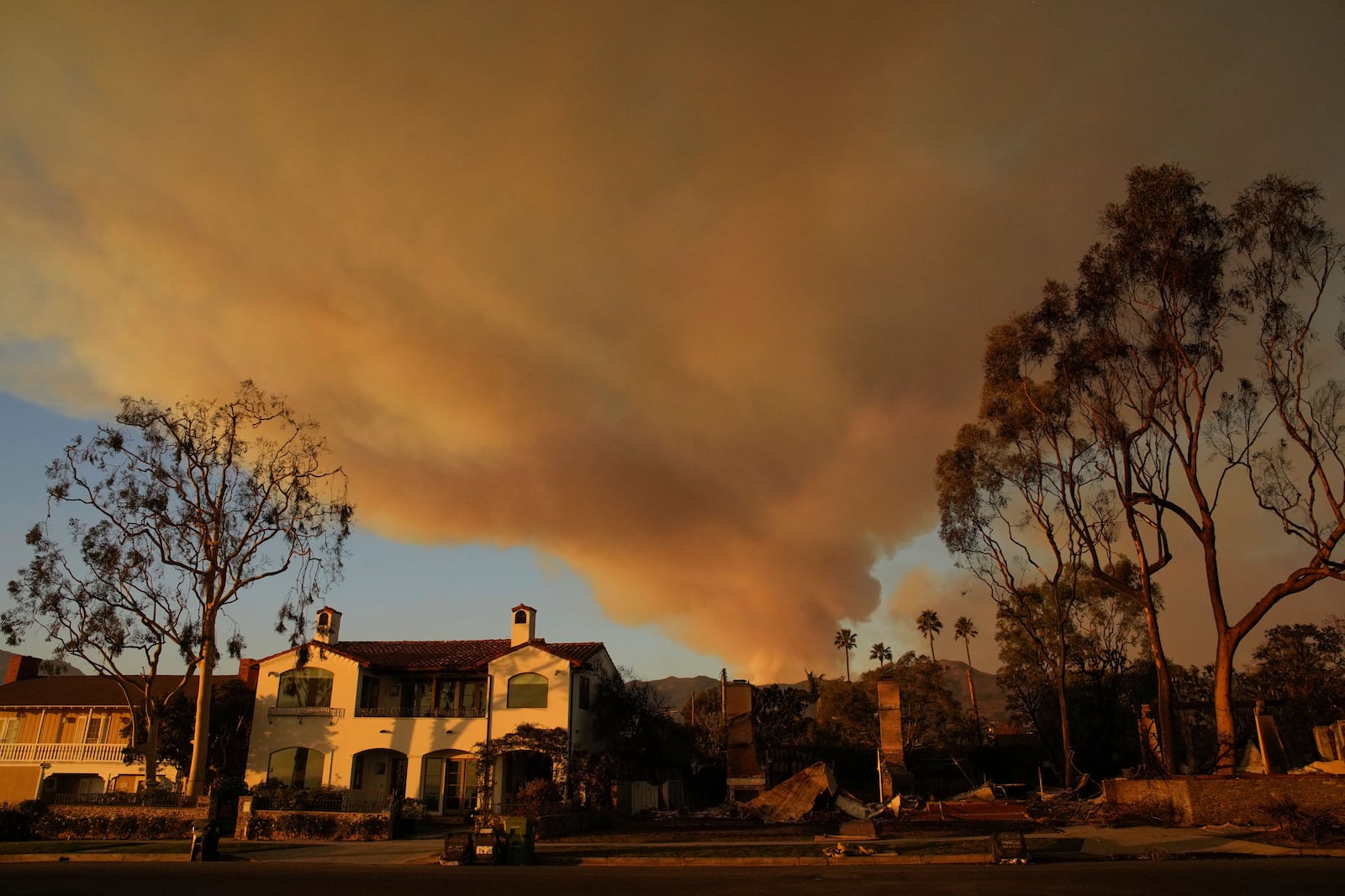 A plume of smoke rises from the Palisades Fire on Friday, Jan. 10, 2025, in the Pacific Palisades section of Los Angeles. (AP Photo/John Locher)