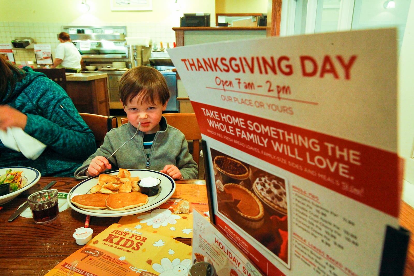 Ben Thompson, 3, pictured, has breakfast with his mother Tanya Thompson of Denver, Colo. and his sister Katy, 8, at the Bob Evans restaurant on Dorothy Lane in Kettering on Monday, November 25. Bob Evans will be among the eateries and retailers opting to be open for business on Thanksgiving Day. CHRIS STEWART / STAFF