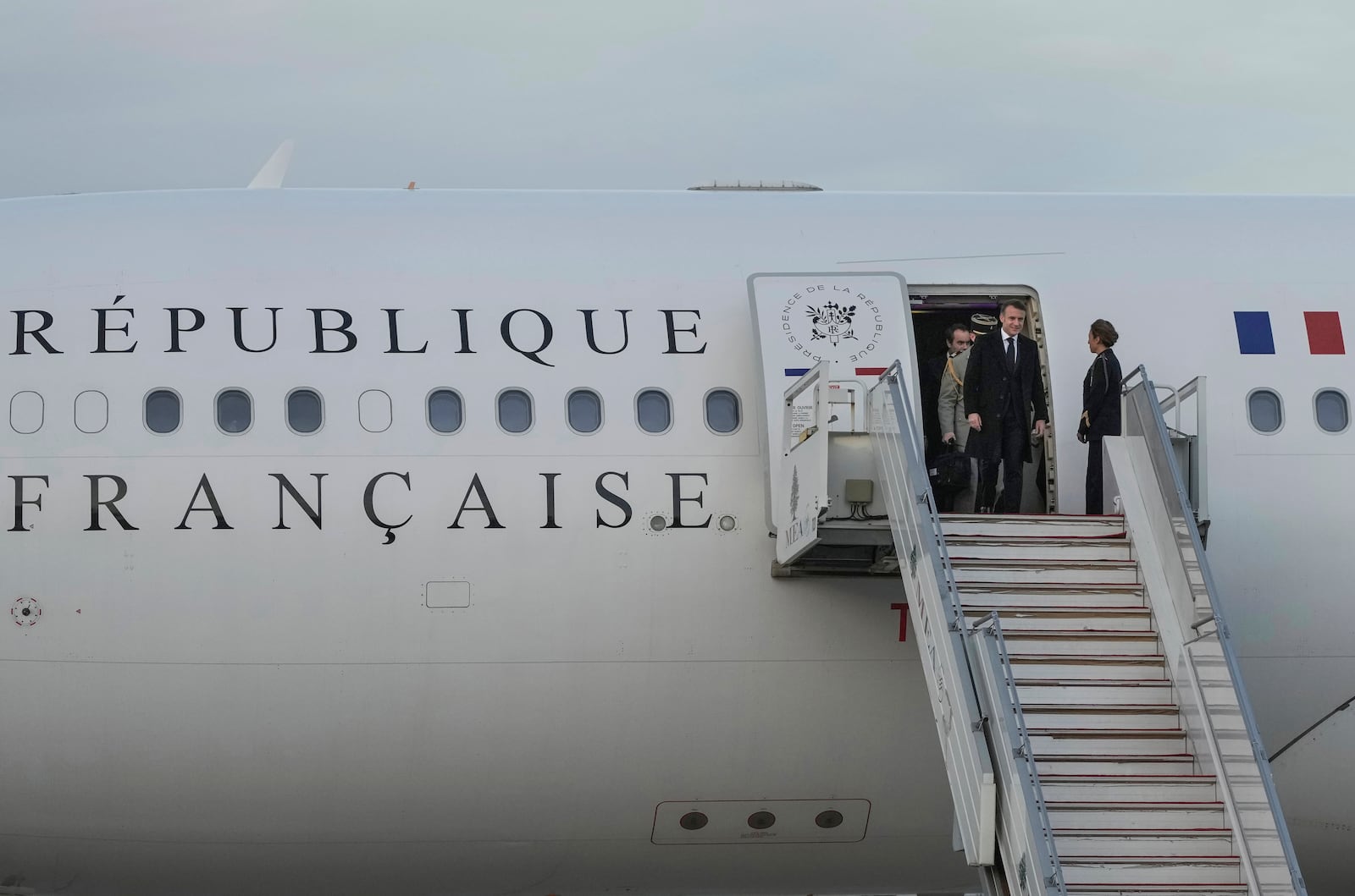 French President Emmanuel Macron gets off from his plane as he arrives at Beirut's Rafic Hariri International Airport in Beirut, Lebanon, Friday, Jan. 17, 2025. (AP Photo/Hassan Ammar)