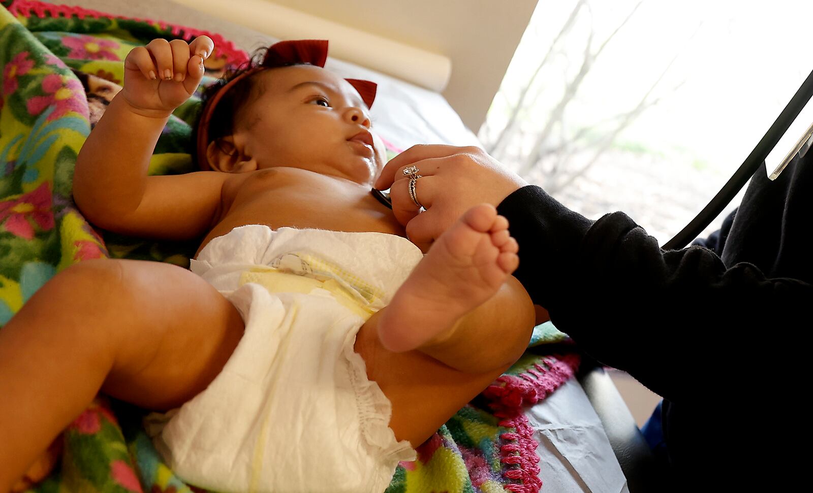 Renata Eliyio, 2-month-old, is examined by Haley McHenry at the Rocking Horse Center Monday, Feb. 6, 2023. BILL LACKEY/STAFF