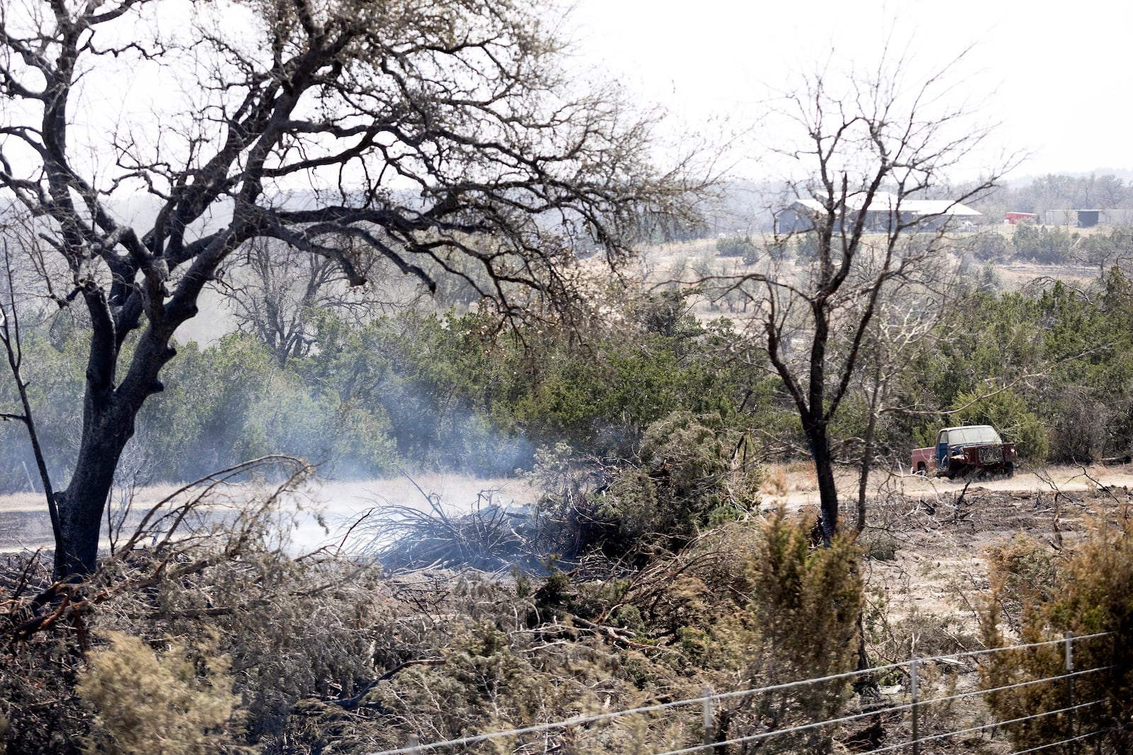 A hotspot in the Crabapple Fire smokes North State Highway 16 near Fredericksburg, Texas, Monday, March 17, 2025. (Josie Norris/The San Antonio Express-News via AP)