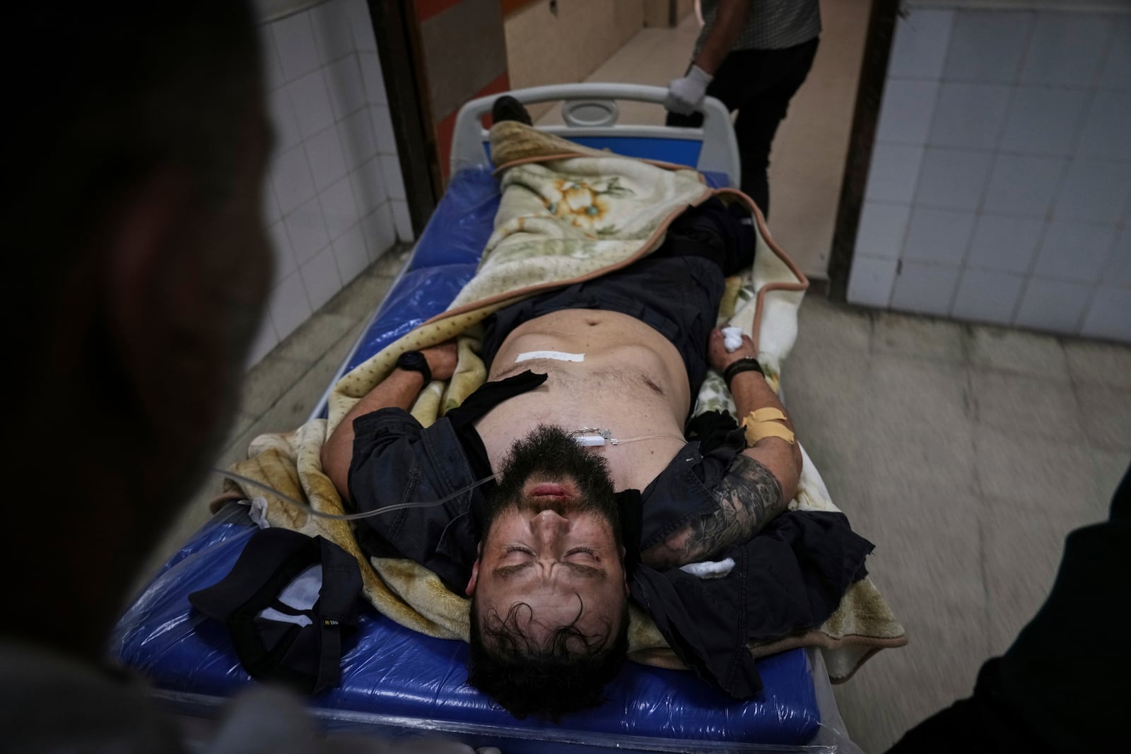 An injured United Nations Mine Action Service (UNMAS) worker is taken into the al-Aqsa Martyrs hospital after an explosion in Deir al-Balah in central Gaza, Wednesday March 19, 2025.(AP Photo/Abdel Kareem Hana)