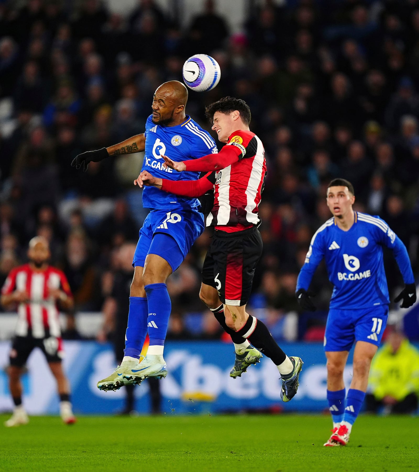 Leicester City's Jordan Ayew, left, and Brentford's Christian Norgaard battle for a head ball during the Premier League soccer match at the King Power Stadium in Leicester, England, Friday, Feb. 21, 2025. (Mike Egerton/PA via AP)