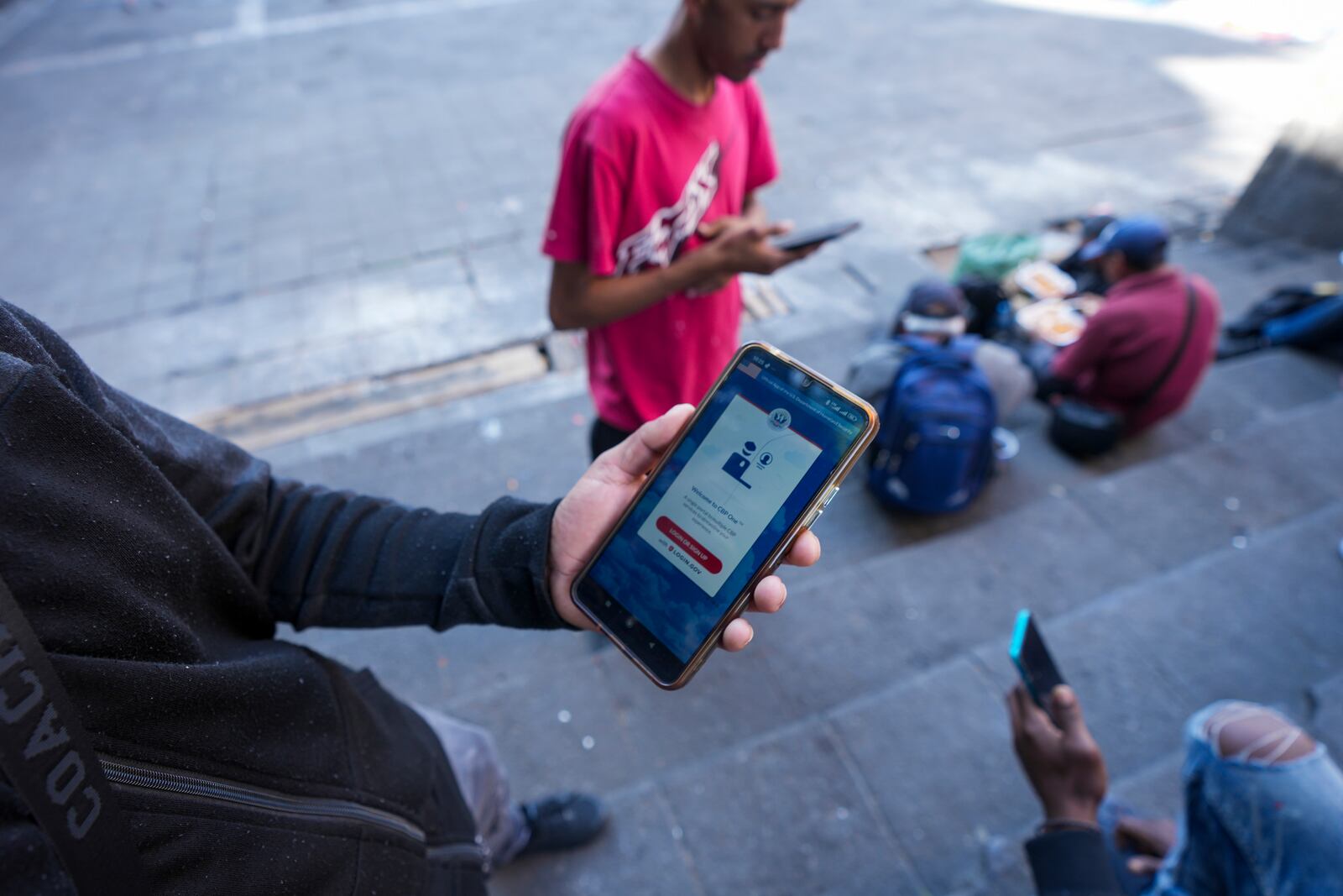 Yender Romero, from Venezuela, shows the U.S. Customs and Border Protection (CBP) One app on his cell phone, which he said he used to apply for asylum in the U.S. and is waiting on an answer, at a migrant tent camp outside La Soledad church in Mexico City, Monday, Jan. 20, 2025. (AP Photo/Fernando Llano)