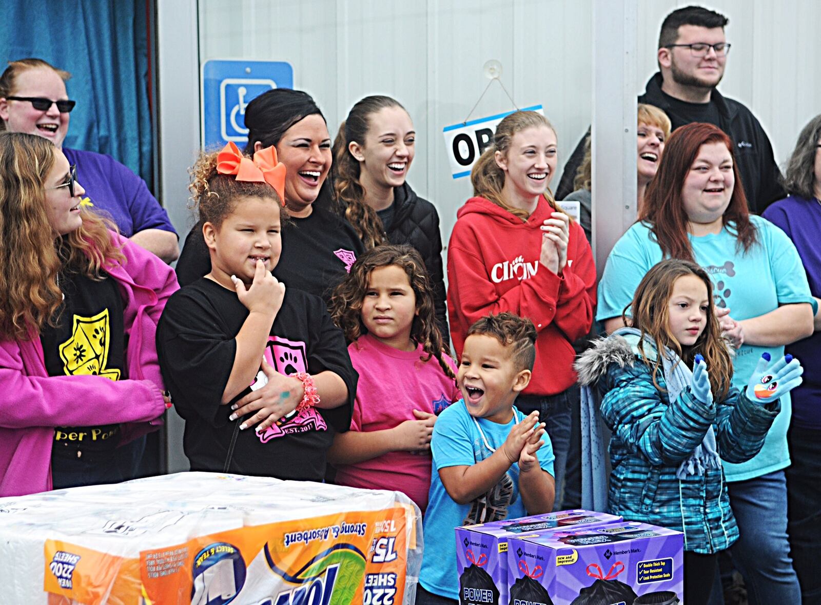 Pawsitive Warriors Rescue In New Carlisle Volunteers React while receiving gifts from the Canine Justice Network Sunday. Staff Photo Marshall Gorby