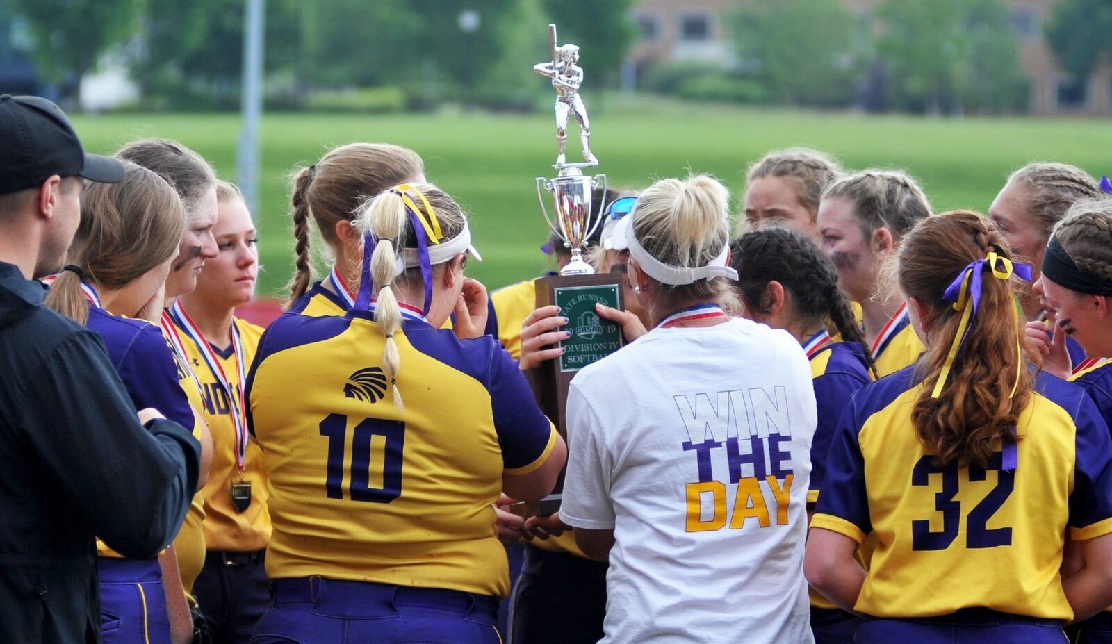 The Mechanicsburg softball team takes a look at the Division II state runner-up trophy Sunday after the Indians lost to Antwerp 5-0 at Firestone Stadium in Akron. RICK CASSANO/STAFF