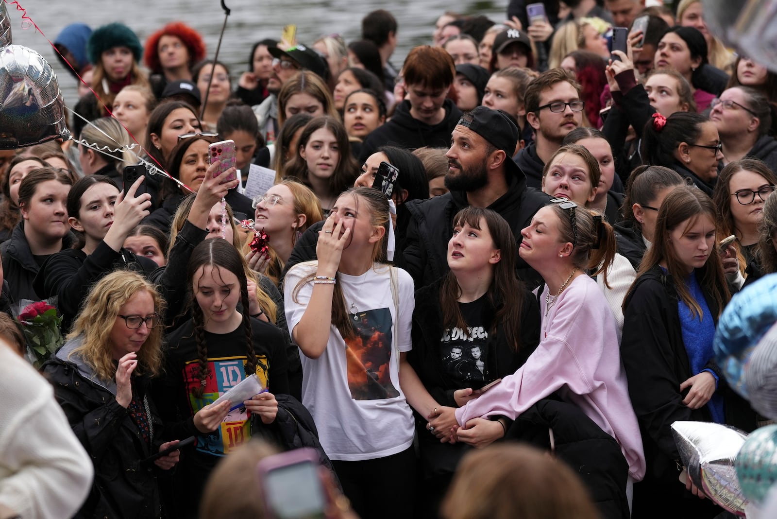 Fans gather to pay tribute to late British singer Liam Payne, former member of the British pop band One Direction in Hyde Park in London, Sunday, Oct. 20, 2024, in London. (Photo by Scott A Garfitt/Invision/AP)