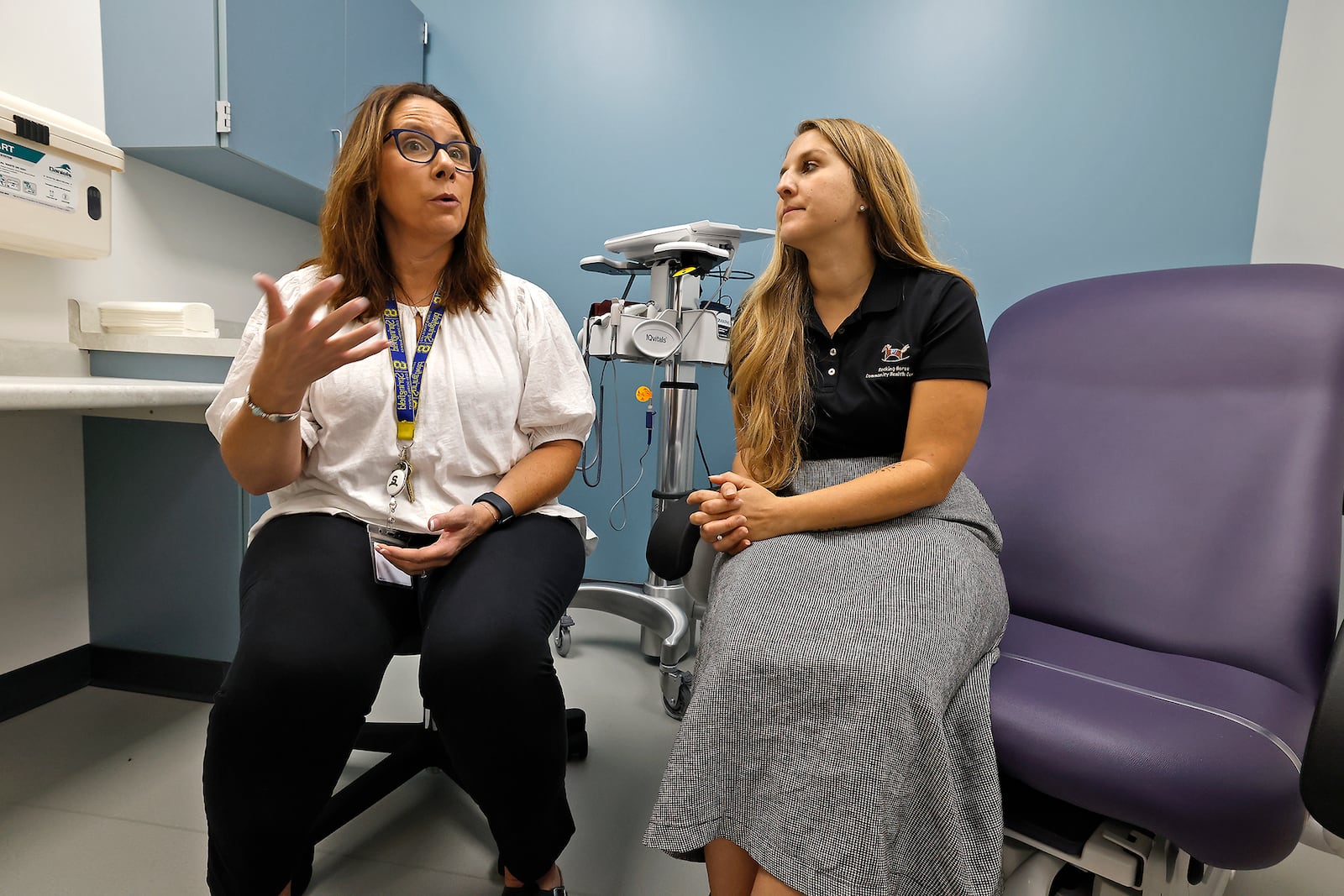 Anita Biles, from Springfield City Schools, left, and Amanda Ambrosio, from the Rocking Horse Center, discuss the success of The Health Center at Springfield High School Thursday, Sept. 26, 2024. While the center has only been open for a few weeks, they have already seen over 100 patients. BILL LACKEY/STAFF