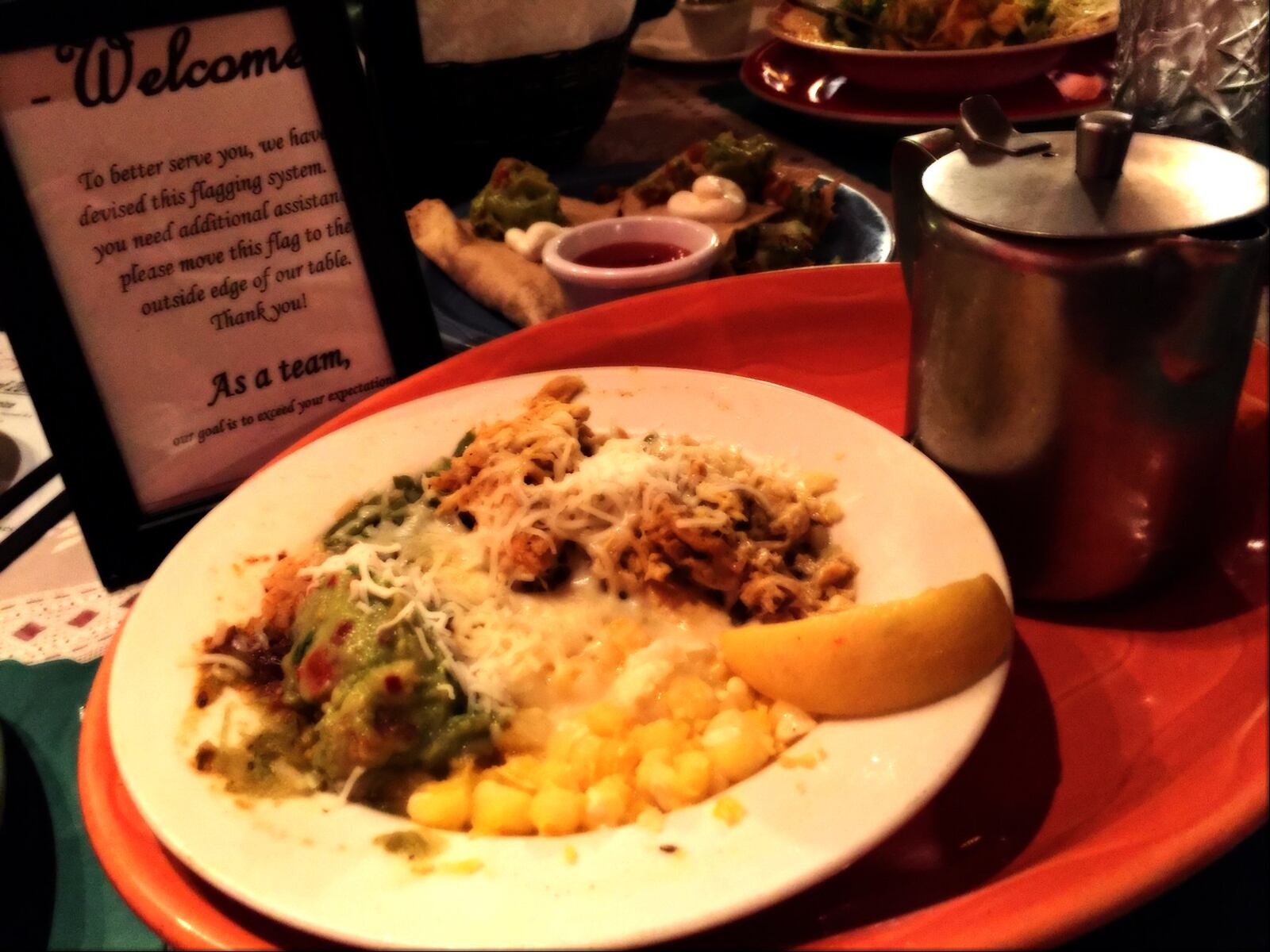 A bowl of Mexican Tortilla Soup ($10) a traditional soup with chicken, rice, hominy, avocado, cheese, and spices served with tortilla strips and broth on the side sits in front of El Meson’s table card to signal the table needs service. Contributed photo by Alexis Larsen