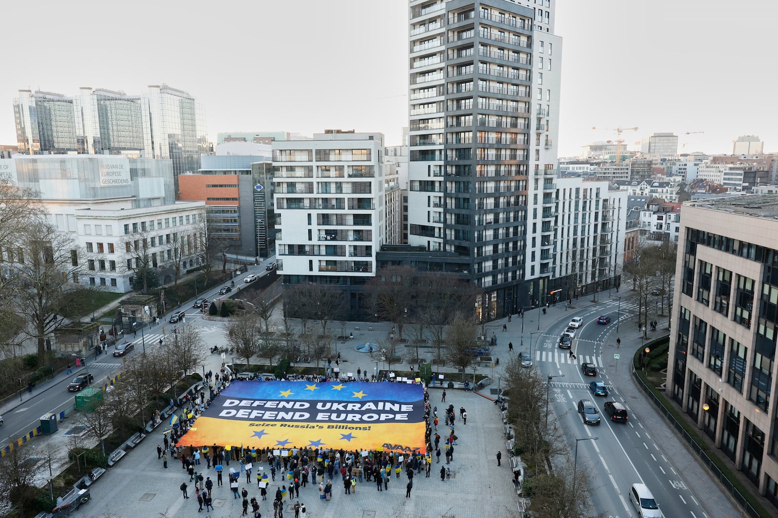 Activists unfurl a large banner in support of Ukraine outside the European Council building ahead of an EU summit in Brussels, Belgium, Wednesday, March 5, 2025. (AP Photo/Omar Havana)