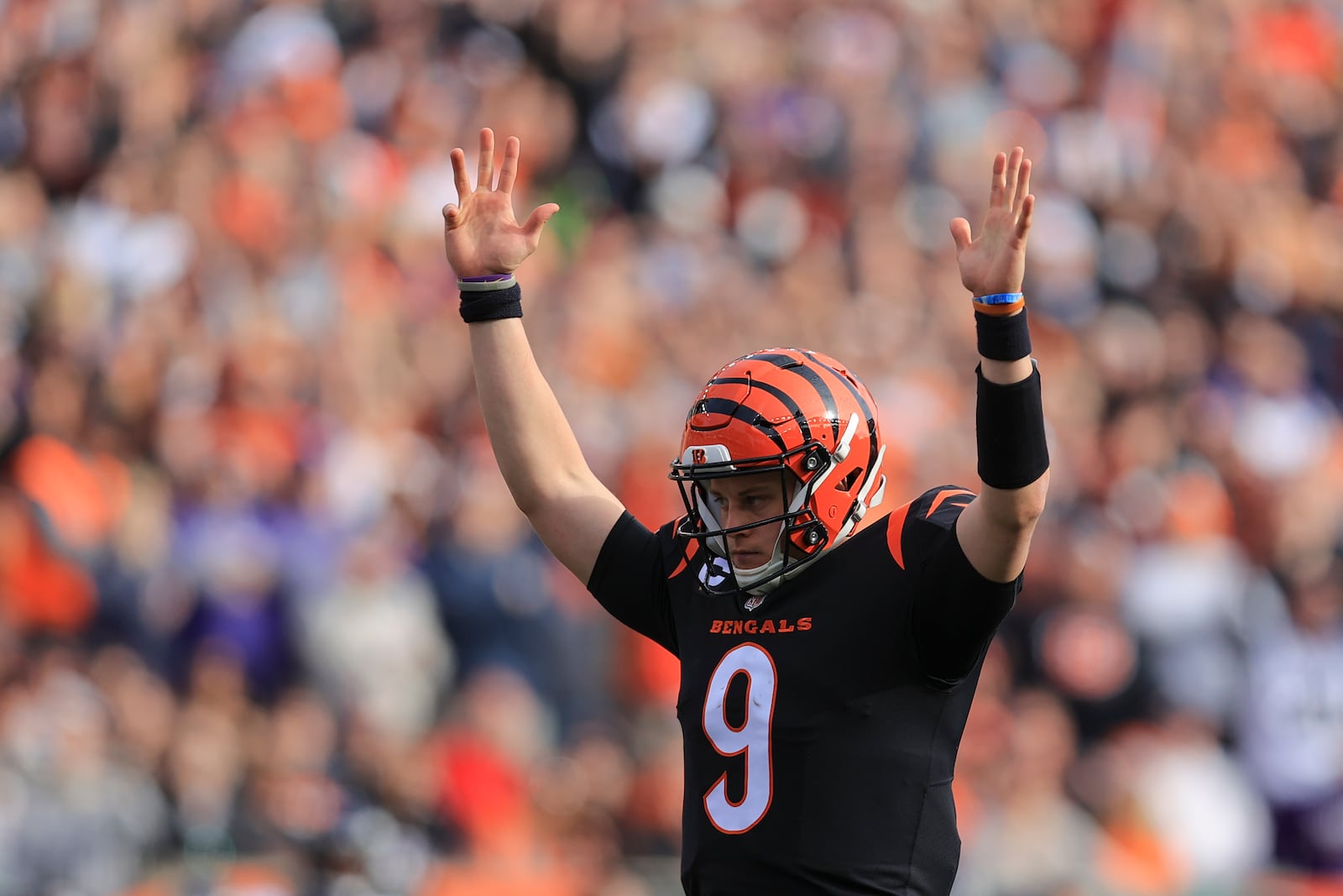 Cincinnati Bengals quarterback Joe Burrow (9) reacts after a touchdown run by Joe Mixon during the first half of an NFL football game against the Baltimore Ravens, Sunday, Dec. 26, 2021, in Cincinnati. (AP Photo/Aaron Doster)