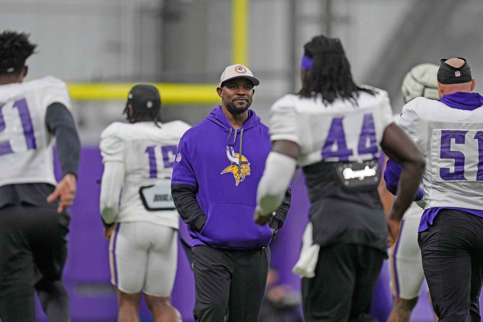 FILE - Minnesota Vikings defensive coordinator Brian Flores, center, stands on the field during an NFL football workout in Eagan, Minn., Wednesday, Oct. 30, 2024. (AP Photo/Abbie Parr, File)