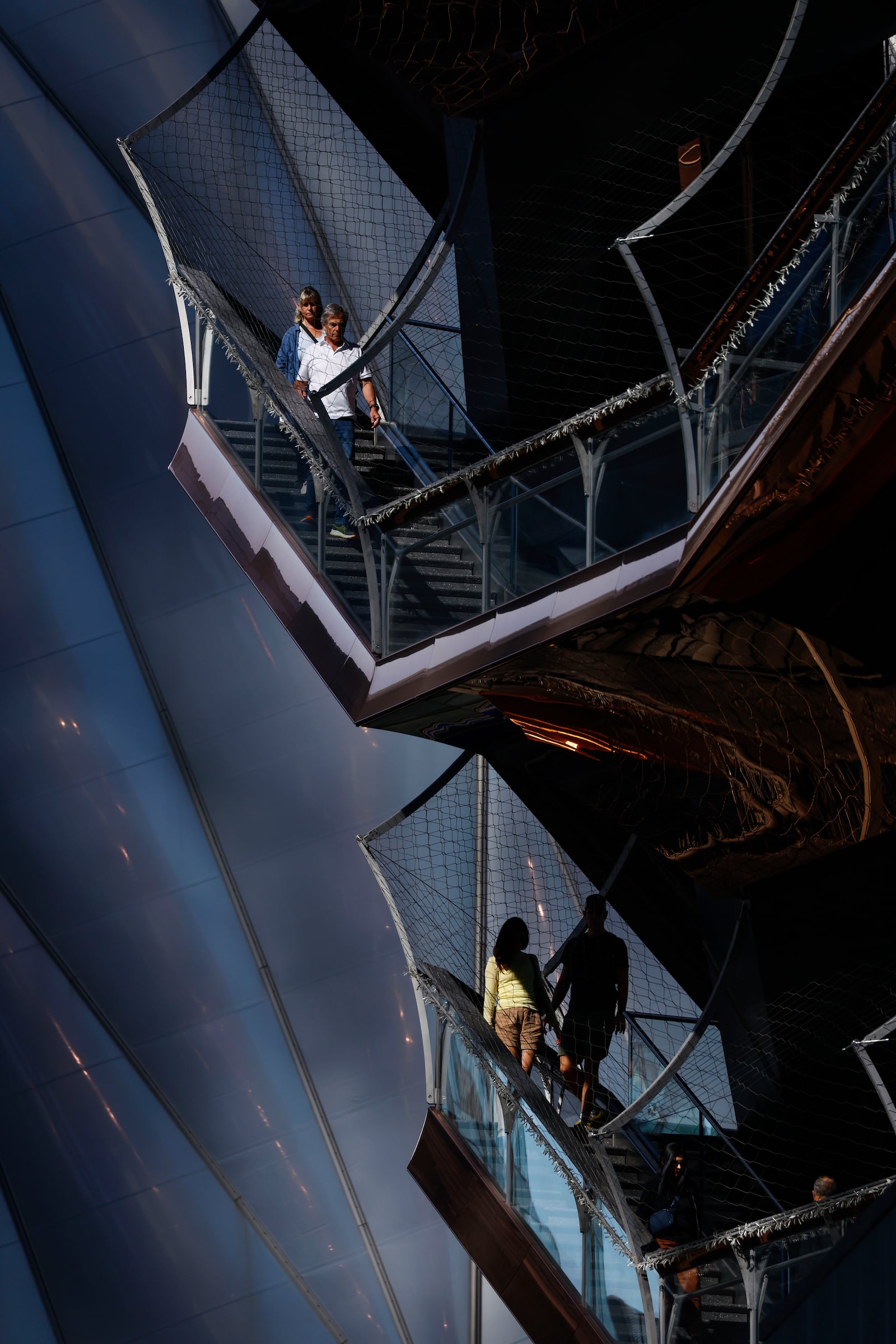 An exterior net covers the structure as people visit the Vessel as it reopens with safety features in New York, Monday, Oct. 21, 2024. (AP Photo/Kena Betancur)