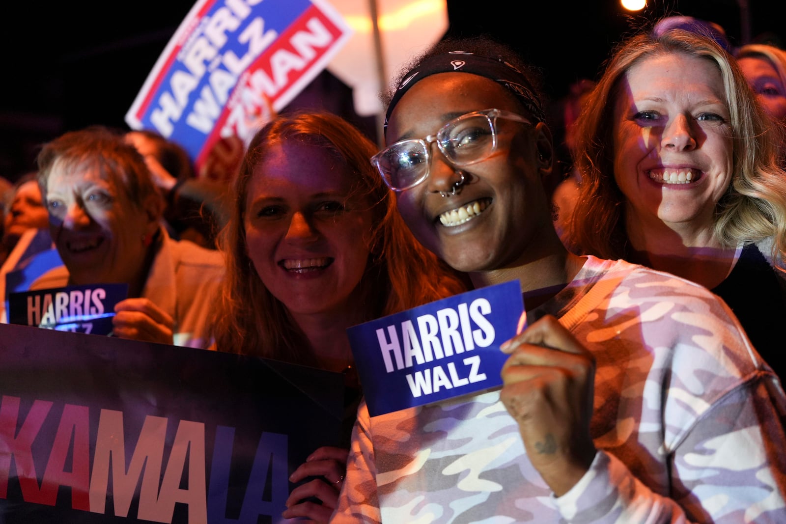 Vice President Kamala Harris supporters Emily Patrick, left, Tiersa Curry, center, and Katie Couch pose as they wait for Harris outside a Puerto Rican restaurant that Harris visited in Reading, Pa., Monday, Nov. 4, 2024. (AP Photo/Luis Andres Henao)