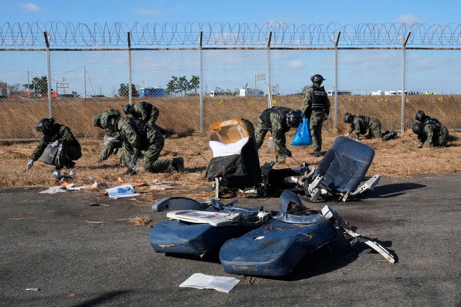 South Korean army soldiers work outside of Muan International Airport in Muan, South Korea, Tuesday, Dec. 31, 2024. (AP Photo/Ahn Young-joon)