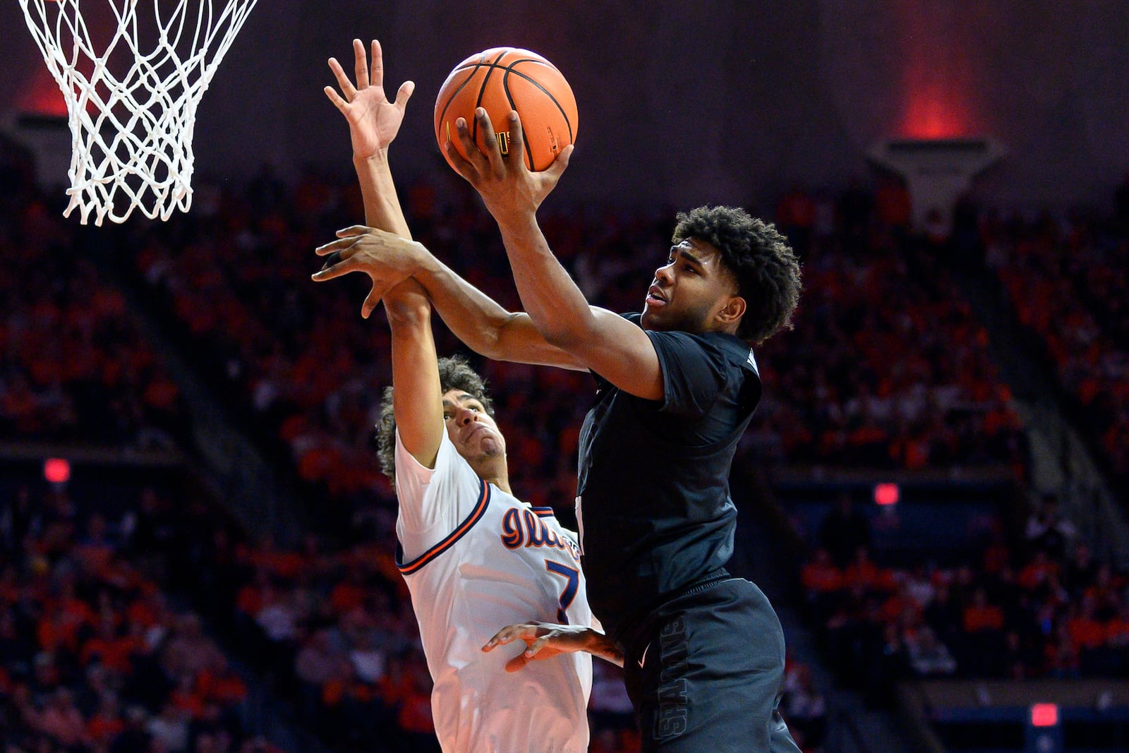 Illinois' Will Riley attempts to block Michigan State's Jase Richardson during the second half of an NCAA college basketball game Saturday, Feb. 15, 2025, in Champaign, Ill. (AP Photo/Craig Pessman)