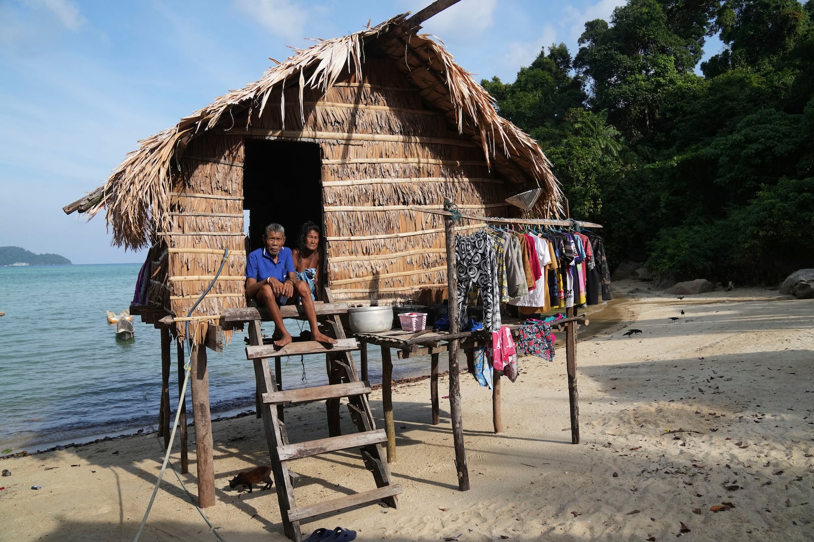 Jepen Klathale and his wife Boomkoyoung Klathale sit on their house in Moken village at Surin Islands in Phang Nga Province, Thailand, Wednesday, Dec. 11, 2024. (AP Photo/Sakchai Lalit)