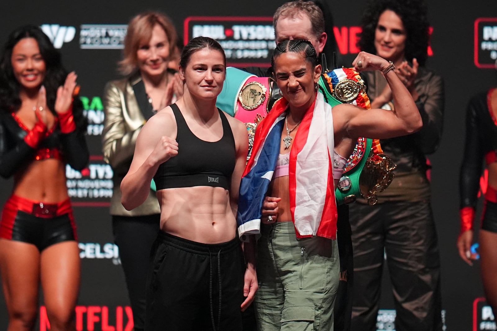 Katie Taylor, left, and Amanda Serranon pose during a weigh-in ahead of their undisputed super lightweight title bout, Thursday, Nov. 14, 2024, in Irving, Texas. (AP Photo/Julio Cortez)