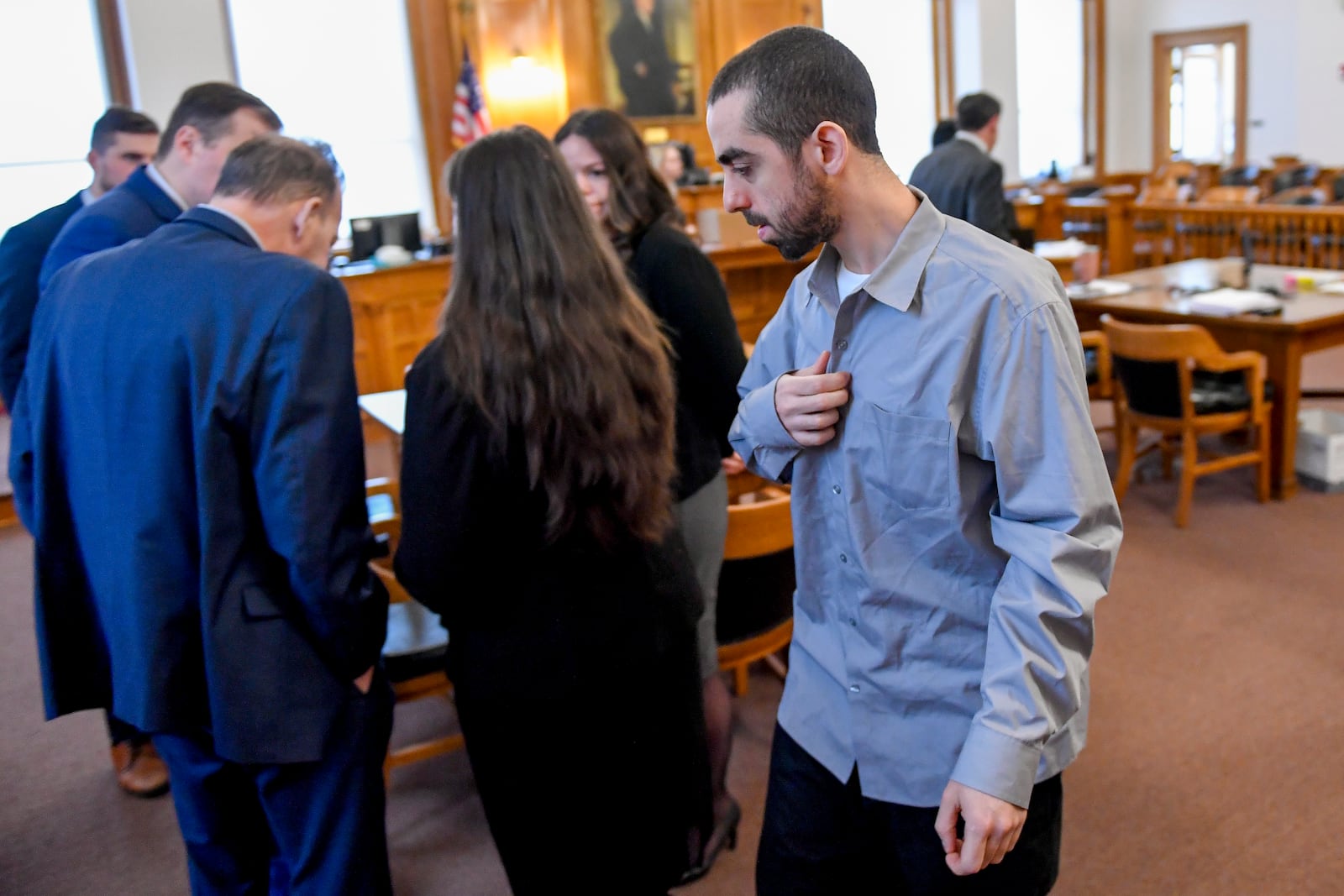 Hadi Matar, right, charged with severely injuring author Salman Rushdie in a 2022 knife attack, walks in to Chautauqua County court as his defense team huddles in Mayville, N.Y., Thursday, Feb. 20, 2025. (AP Photo/Adrian Kraus)