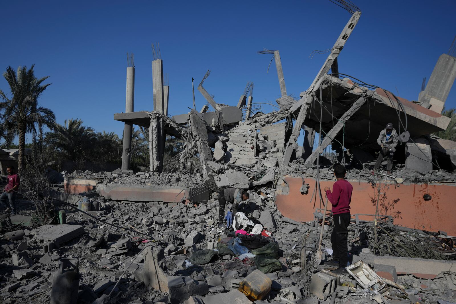 Palestinians check the rubble of a destroyed building following an overnight Israeli strike in Deir al-Balah, Gaza Strip, Wednesday, Dec. 4, 2024. (AP Photo/Abdel Kareem Hana)