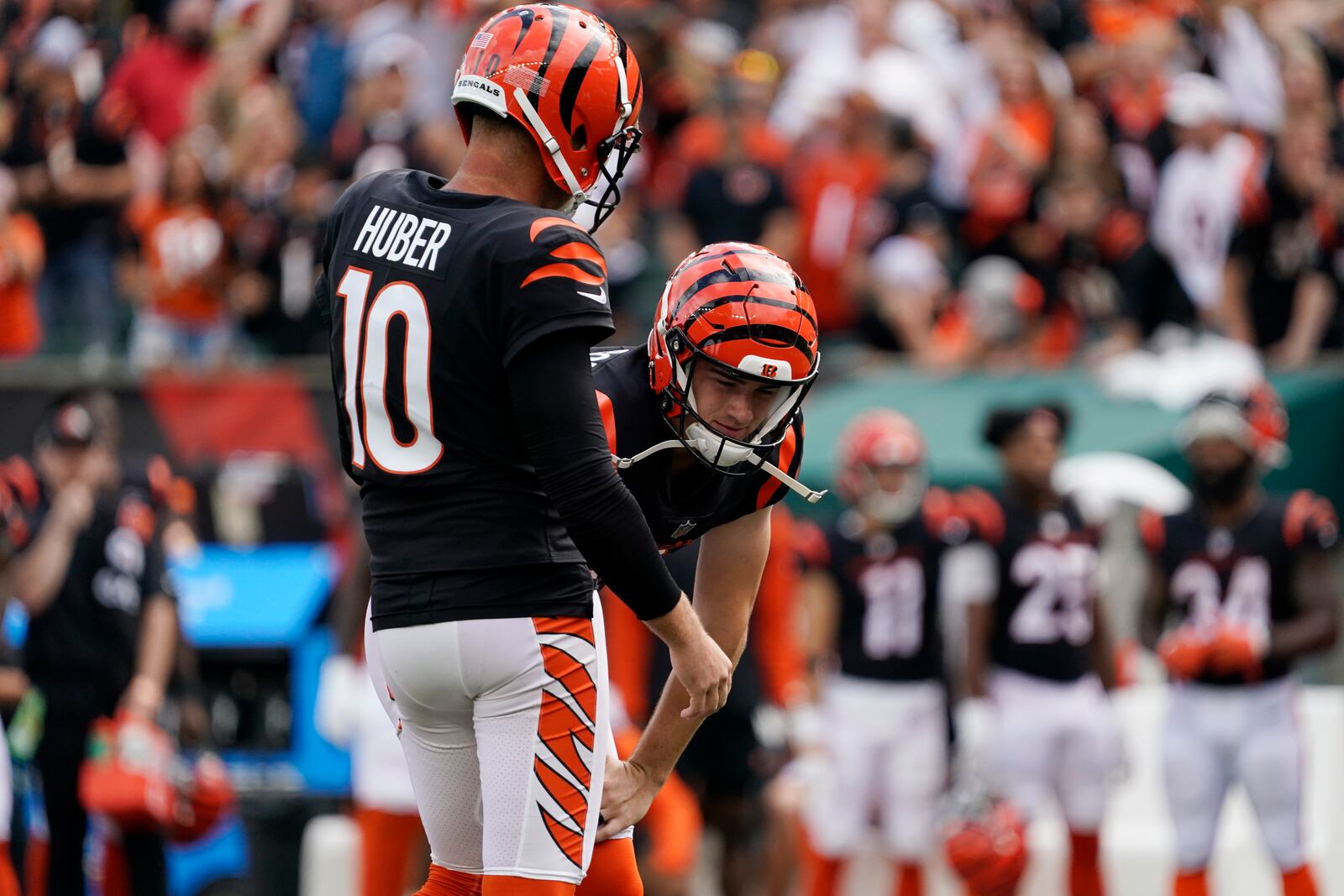 Cincinnati Bengals placekicker Evan McPherson, right, reacts after missing a field goal out of the hold of punter Kevin Huber (10) during overtime of an NFL football game against the Pittsburgh Steelers, Sunday, Sept. 11, 2022, in Cincinnati. (AP Photo/Joshua A. Bickel)