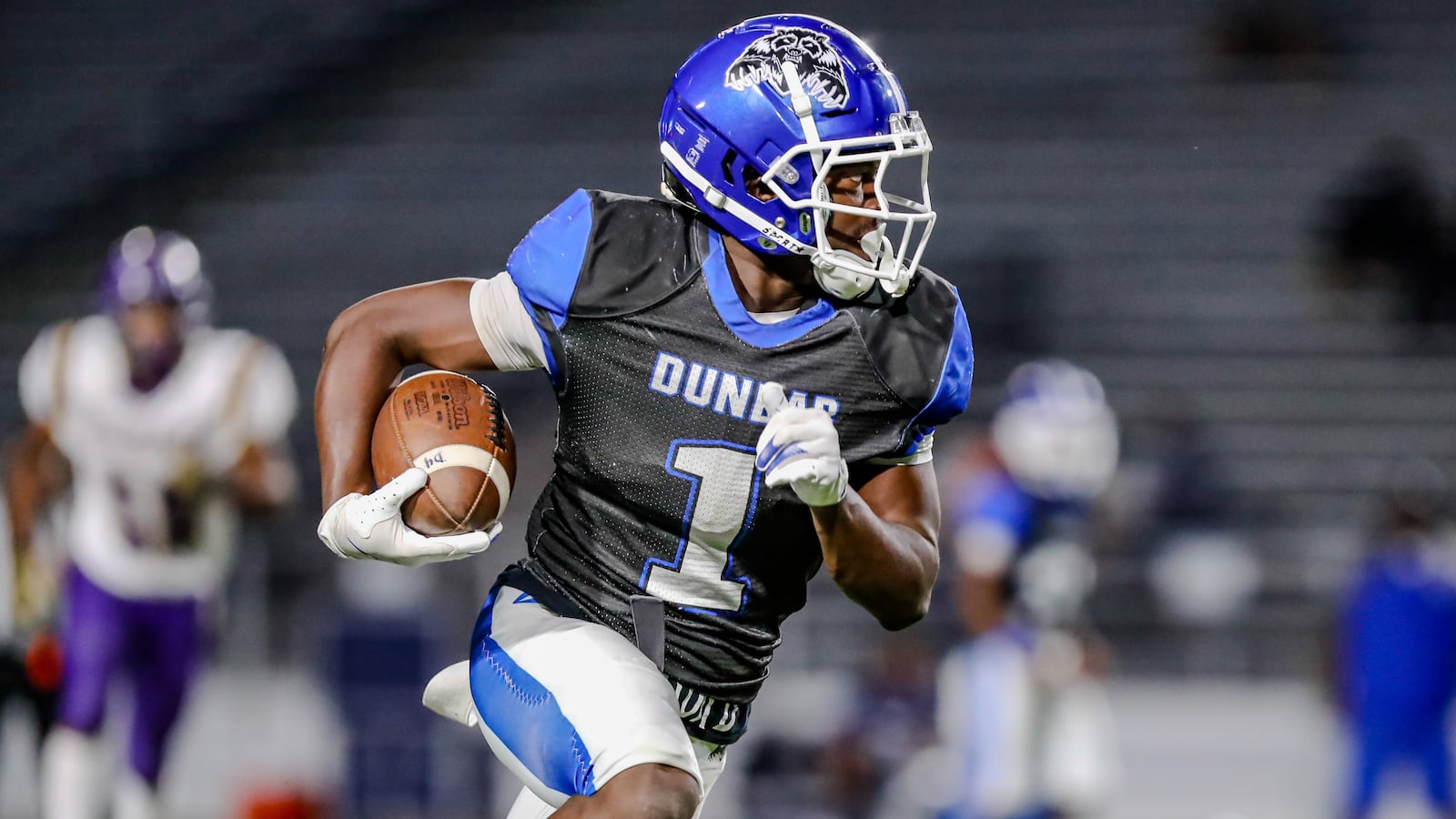 Dunbar High School junior William Wilson runs the ball during their game against Thurgood Marshall on Thursday, Sept. 26 at Dayton Welcome Stadium. The Wolverines won 22-6. Michael Cooper/CONTRIBUTED