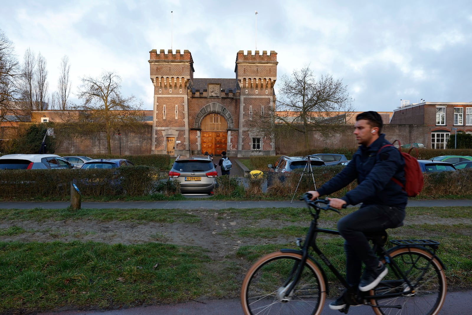 A cyclist drives past one of the entrances to the International Criminal Court detention center near The Hague in Scheveningen, Netherlands, Wednesday, March 12, 2025. (AP Photo/Omar Havana)