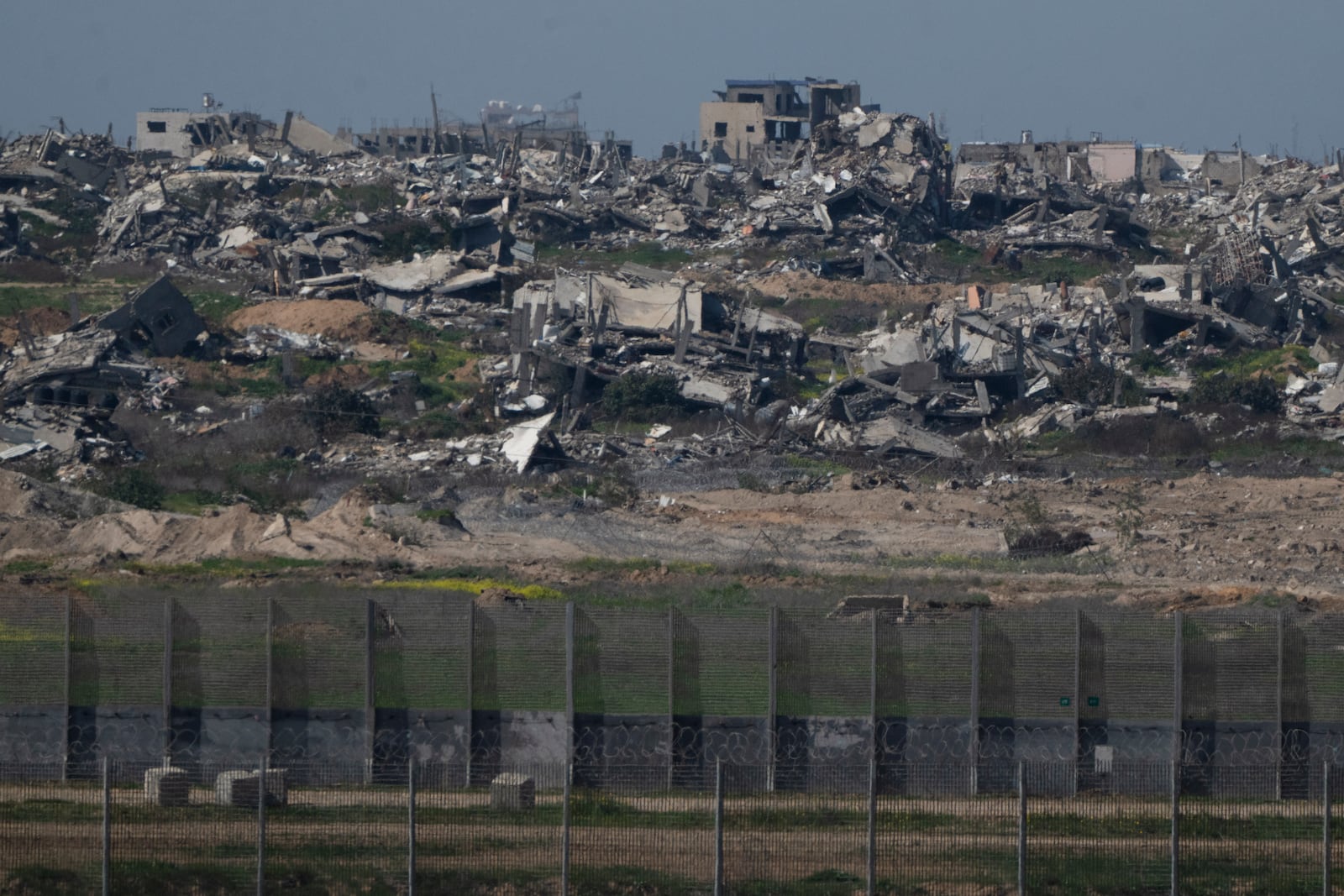 Destroyed buildings stand in the Gaza Strip as seen from southern Israel, Sunday, March 2, 2025. (AP Photo/Leo Correa)